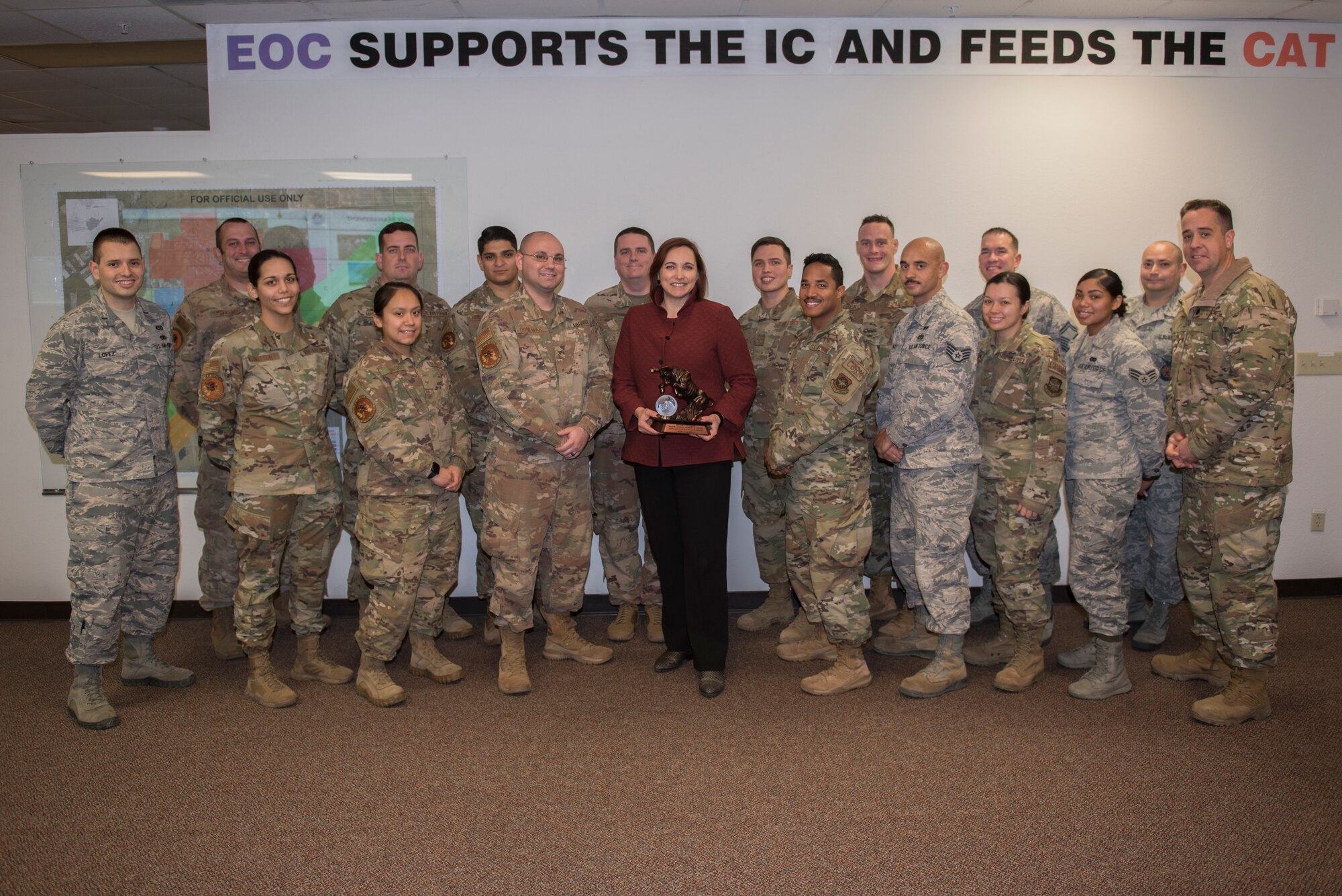 Members from the 60th Civil Engineer Squadron pose for a photo holding their Squadron of the Year award Dec. 14, 2019, at Travis Air Force Base, California. The Squadron of the year award is given out to the squadron that had the best performance throughout the year. (U.S. Air Force photo by Airman 1st Class Cameron Otte)