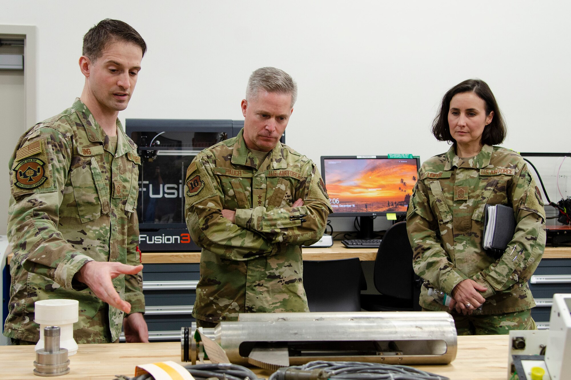 Master Sgt. Joseph King (left), superintendent of maintenance operations at the Air Force Technical Applications Center's Central Repair Facility, explains to 16th Air Force (Air Forces Cyber) Commander Lt. Gen. Timothy Haugh and 16th AF Command Chief Master Sgt. Summer Leifer how the CRF maintains its seismic equipment to execute AFTAC's global nuclear treaty monitoring mission.  The 16th AF leaders visited Patrick AFB, Fla., Dec. 16, 2019.  (U.S. Air Force photo by Susan A. Romano)