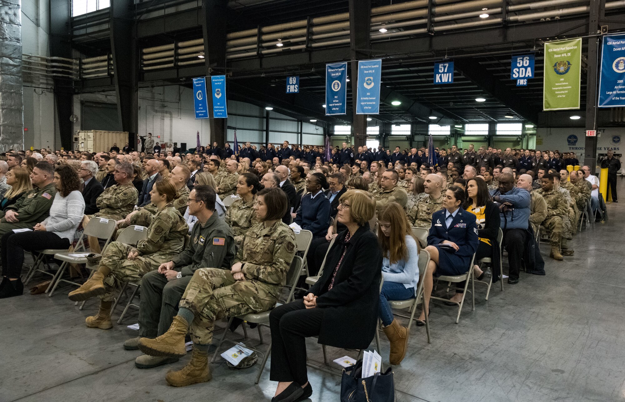 Congressional delegates, civic leaders, family, guests, friends and Team Dover members observe the 436th Airlift Wing Change of Command ceremony Jan. 7, 2020, inside the 436th Aerial Port Squadron on Dover Air Force Base, Del. Presiding officer for the ceremony was Maj. Gen. Sam C. Barrett, 18th Air Force commander. (U.S. Air Force photo by Roland Balik)