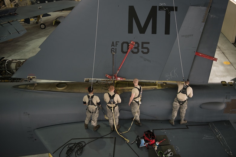 Airmen lower the vertical stabilizer on a B-52H Stratofortress