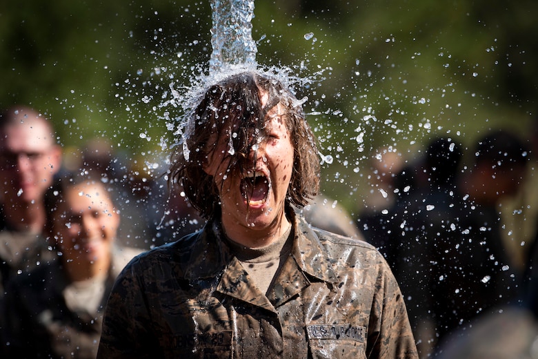 Cadets from the class of 2023 immerse themselves in water after completing the Assault Course