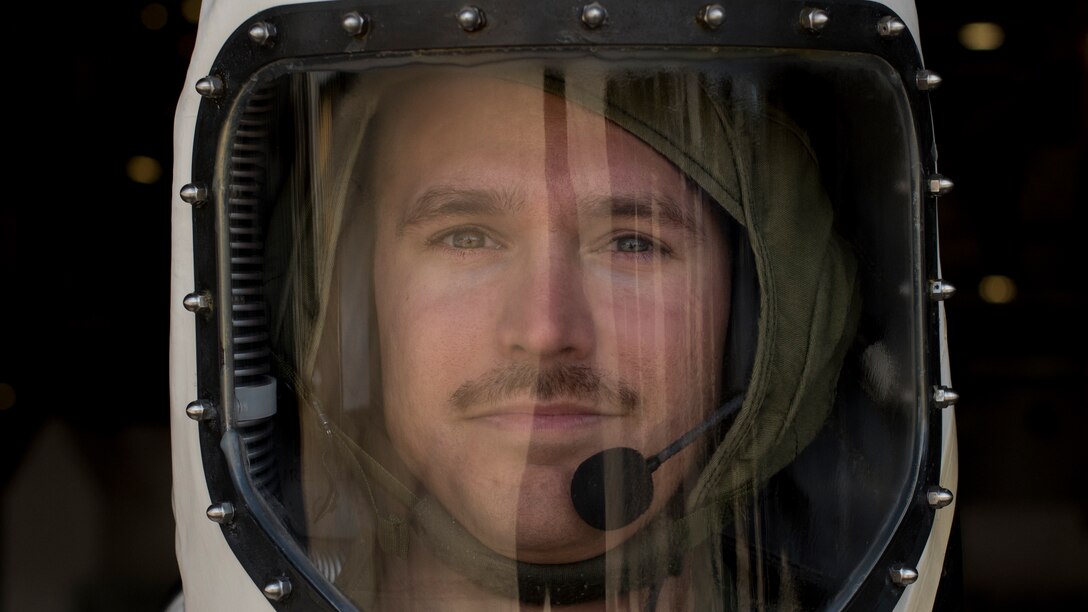 Technician stands in a Self-Contained Atmospheric Protective Ensemble suit