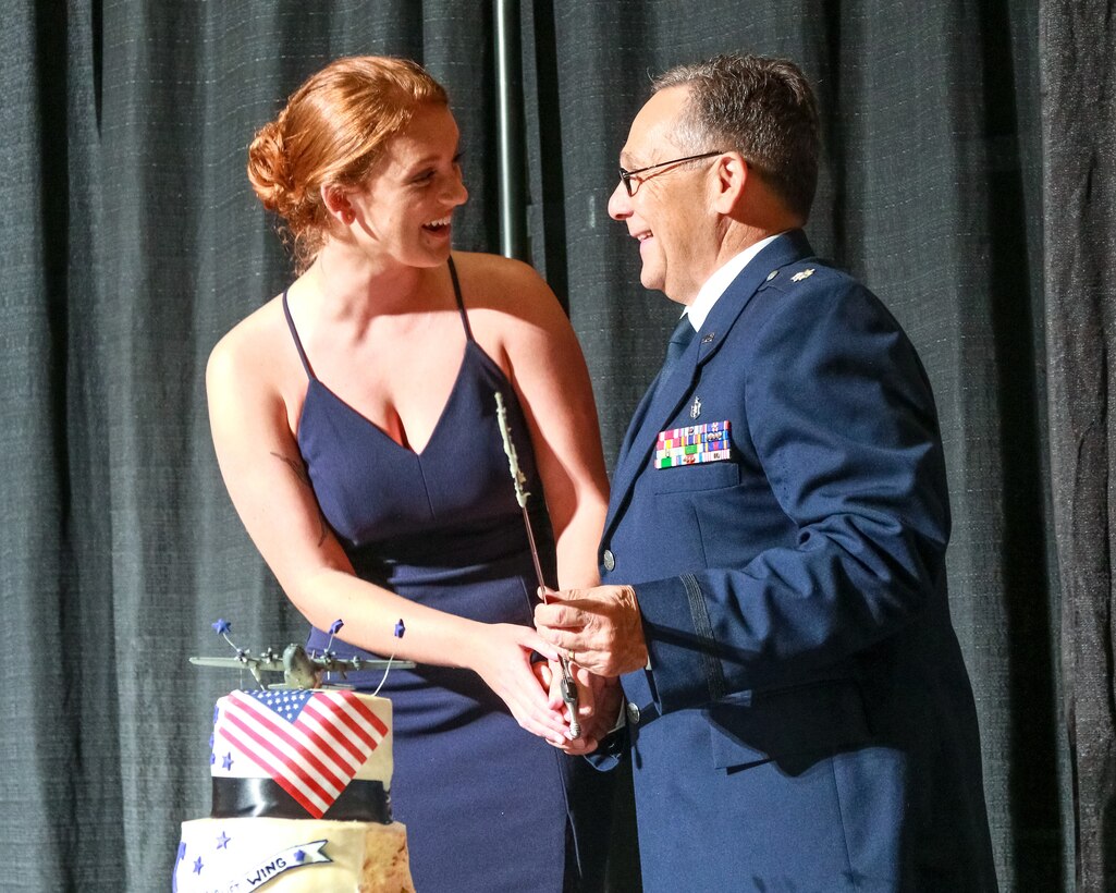 Man and woman cutting cake.