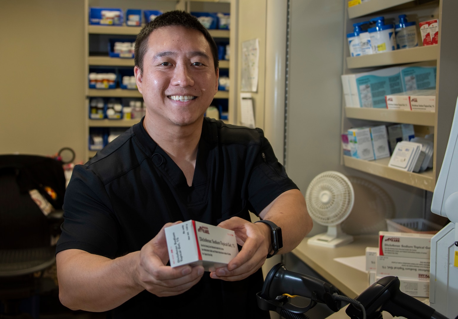 Huy Nguyen, pharmacist, dispenses a prescription in the main pharmacy at Brooke Army Medical Center, Joint Base San Antonio-Fort Sam Houston.