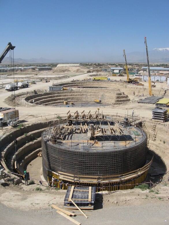 Workers place formwork around bottom of the metal shell of a Cut & Cover tank at Bagram Airfield, Afghanistan.  The formwork will allow the concrete to set against the metal shell and protect the structure.  (Photo by Clay Bolton)