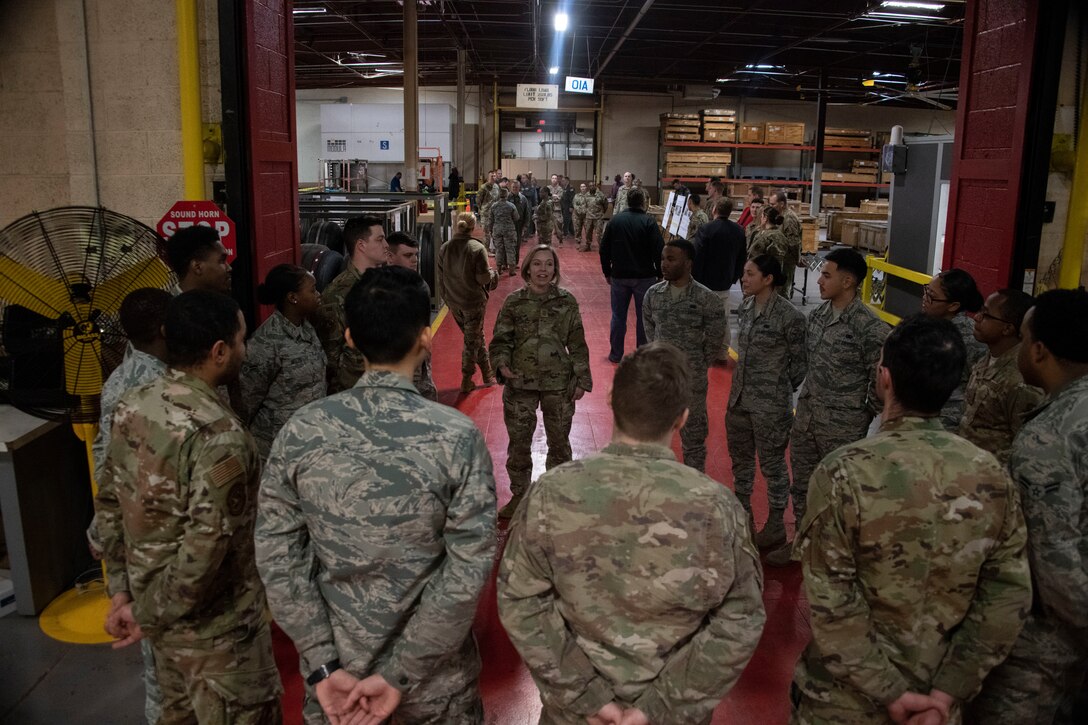 Chief Master Sgt. Julie Gudgel, command chief of Air Education and Training Command, talks with Airmen from the 97th Logistics Readiness Squadron.