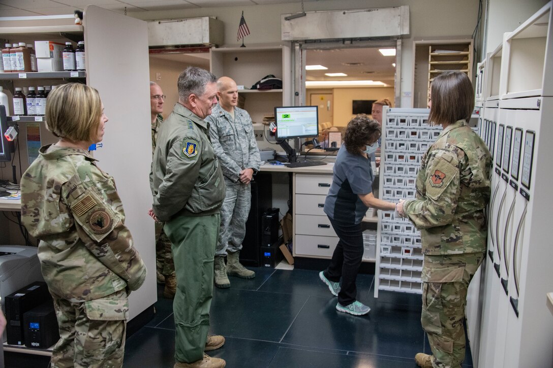 U.S. Air Force Chief Master Sgt. Julie Gudgel, command chief of Air Education and Training Command, and Lt. Gen. Brad Webb, commander of AETC are shown the innovative efforts made to the 97th Medical group pharmacy through the utilization of a new filing system to fill prescriptions,