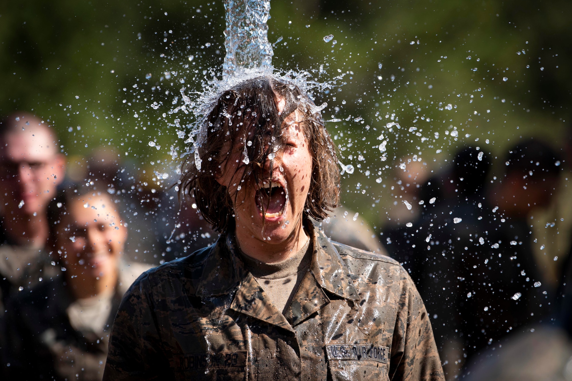 Cadets from the class of 2023 immerse themselves in water after completing the Assault Course