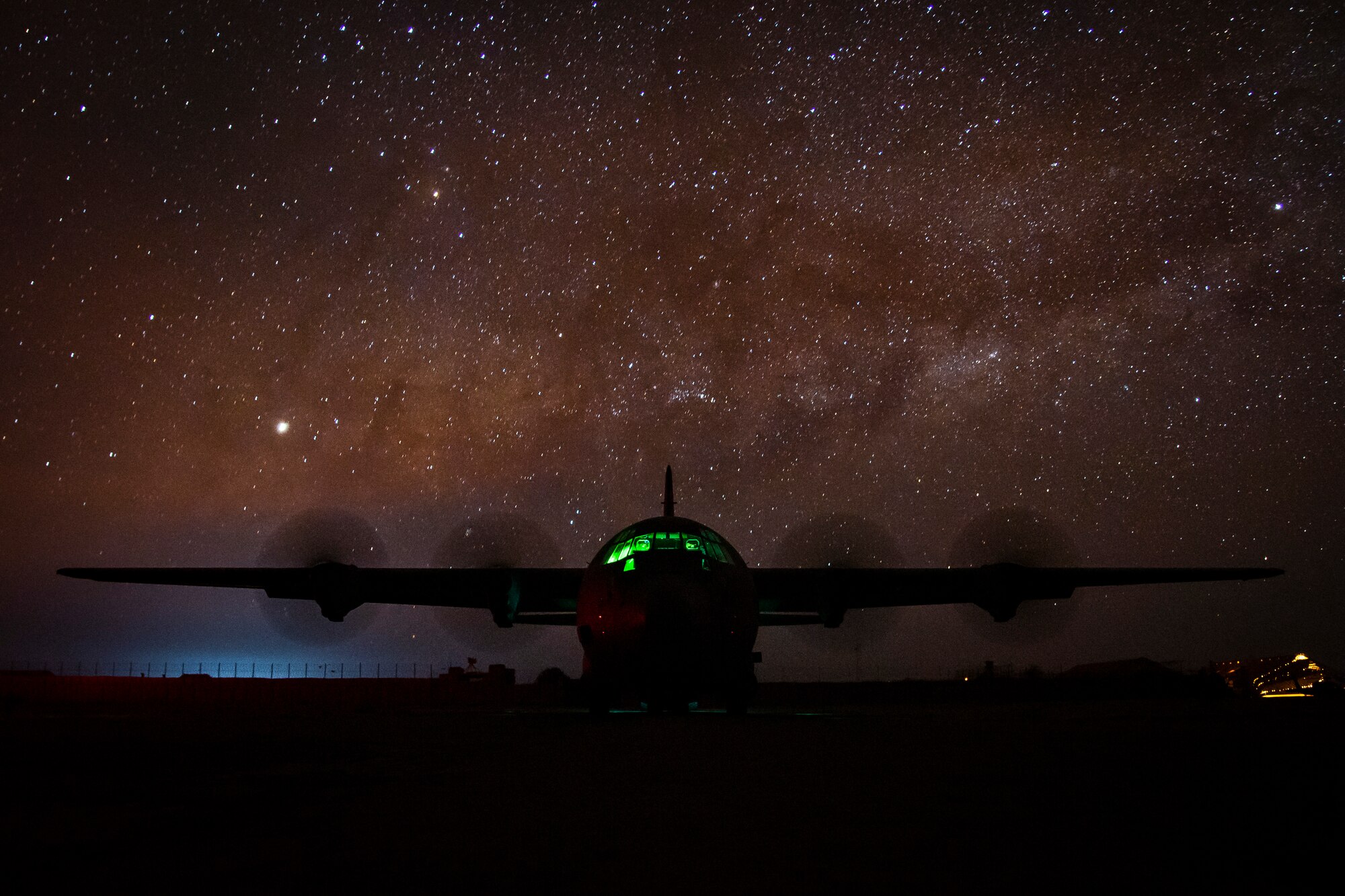 U.S. Airmen unload cargo from a C-130J Hercules