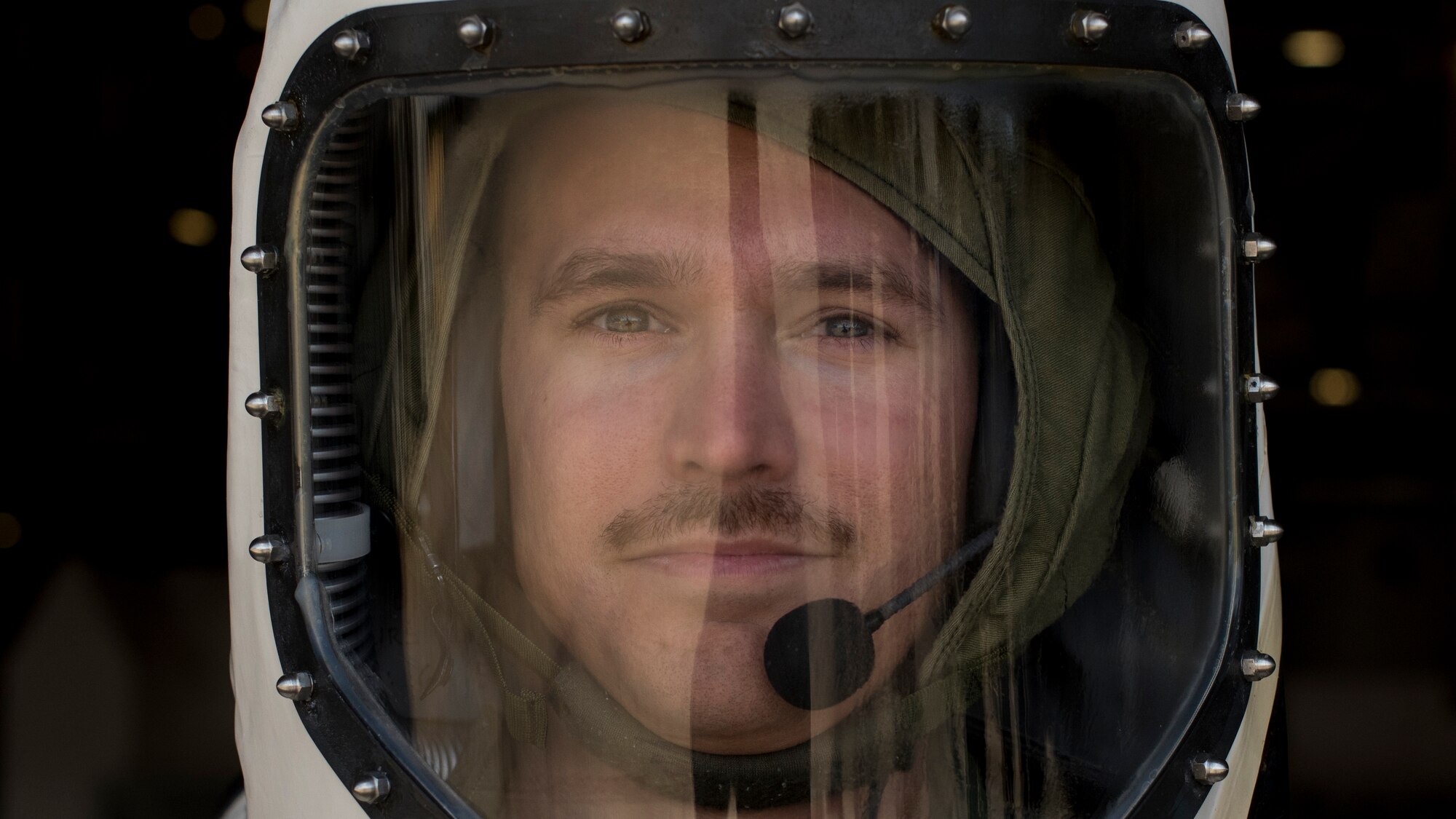 Technician stands in a Self-Contained Atmospheric Protective Ensemble suit