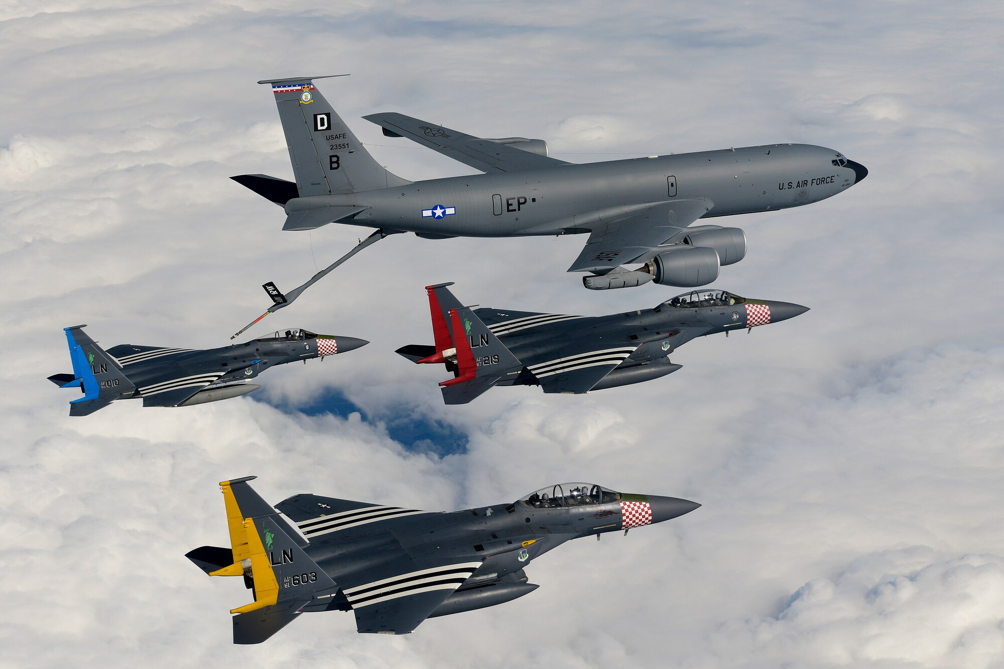 An F-15C Eagle and two F-15E Strike Eagles rendezvous with a KC-135 Stratotanker