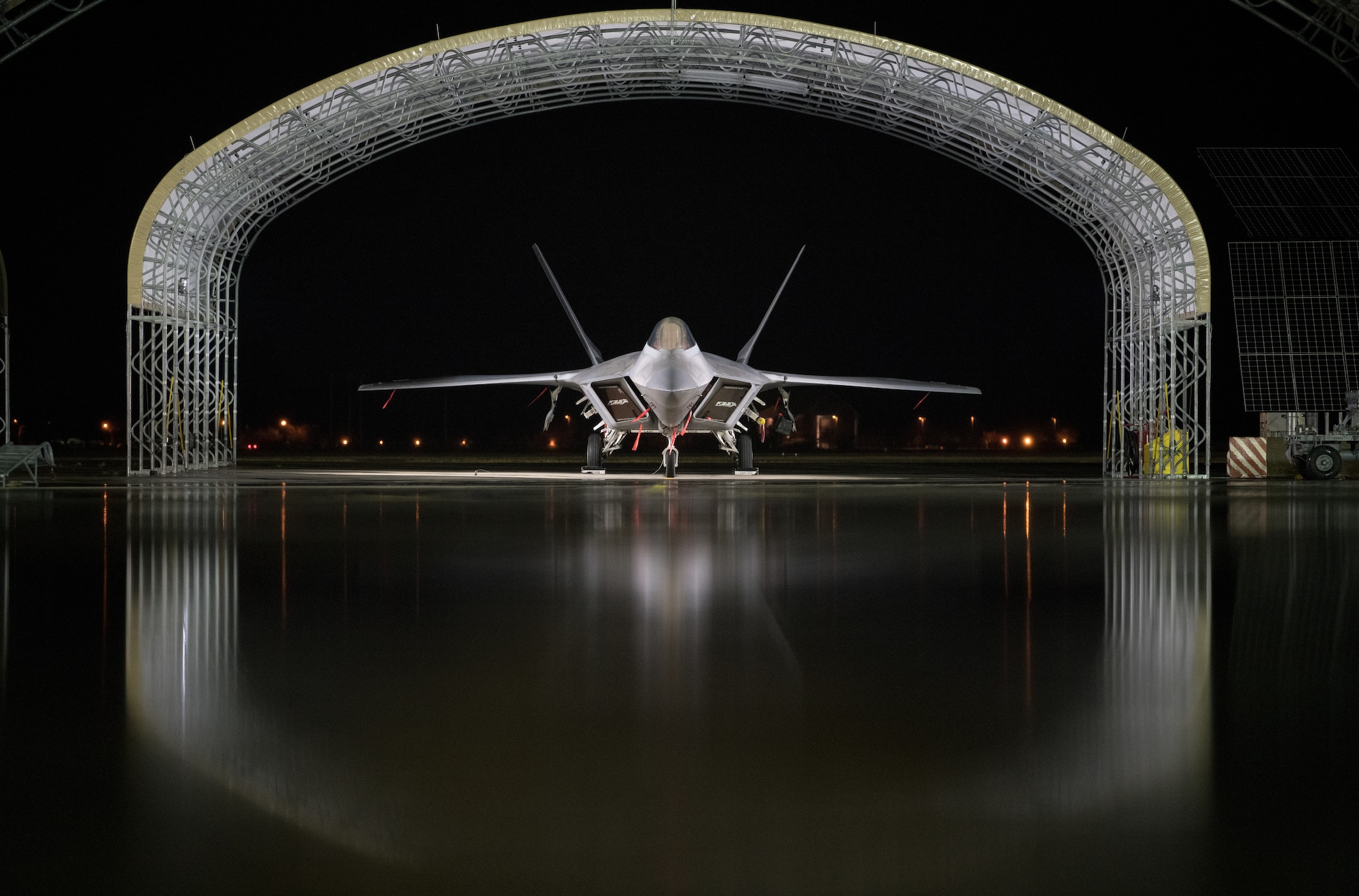 An Air Force F-22 Raptor is parked on the flightline