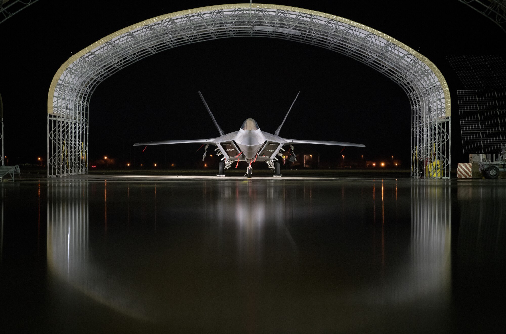 An Air Force F-22 Raptor is parked on the flightline