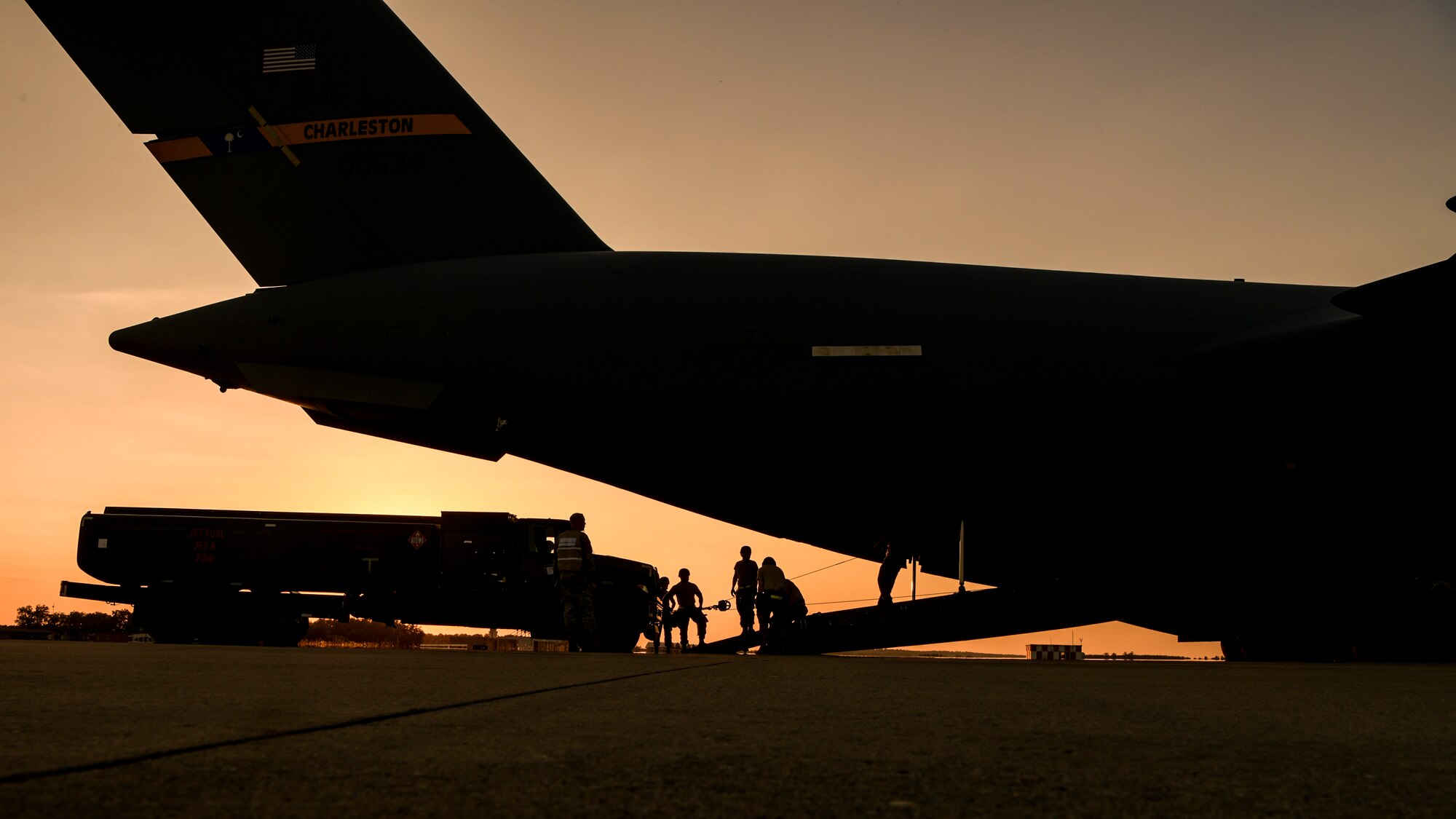Airmen winch an R-11 refueler aboard a C-17 Globemaster III