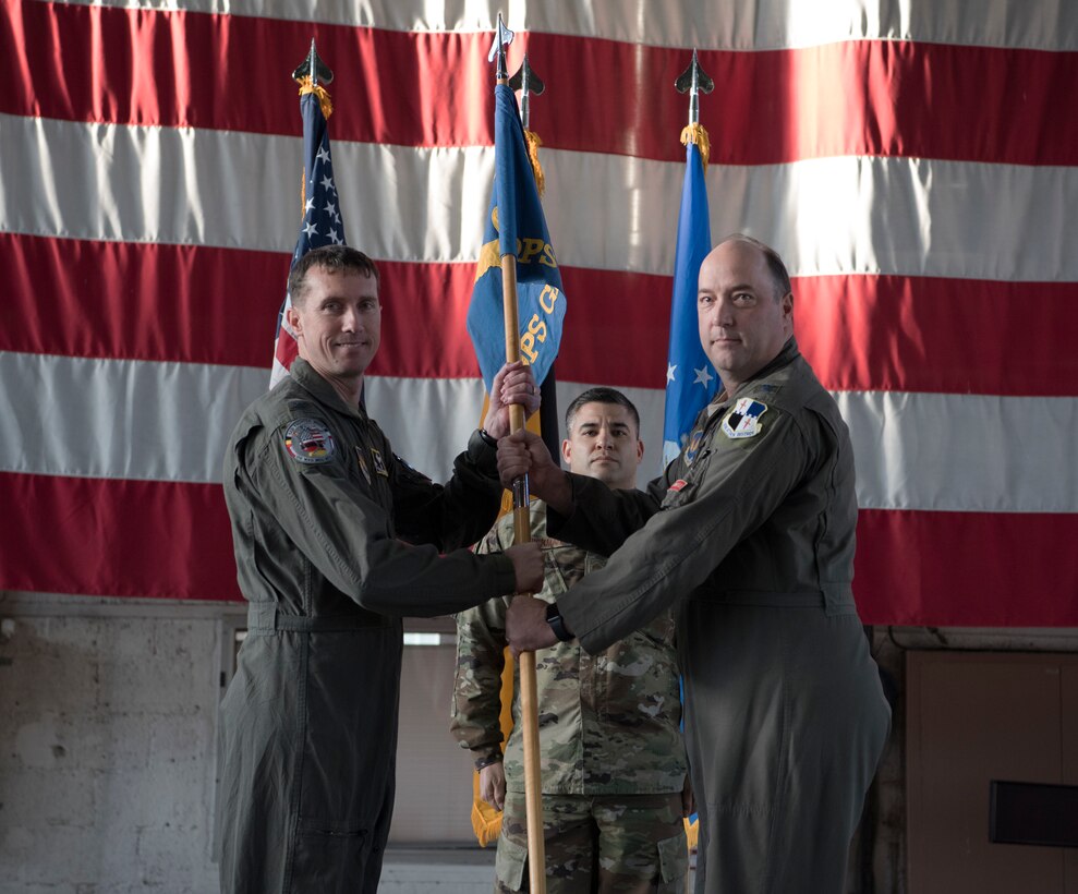 U.S. Air Force Col. Anthony Retka, 52nd Operations Group commander, right, passes the ceremonial guidon to Col. David Epperson, 52nd Fighter Wing commander, left, during the 52nd OG retirement ceremony at Spangdahlem Air Base, Germany, Jan. 6, 2020.