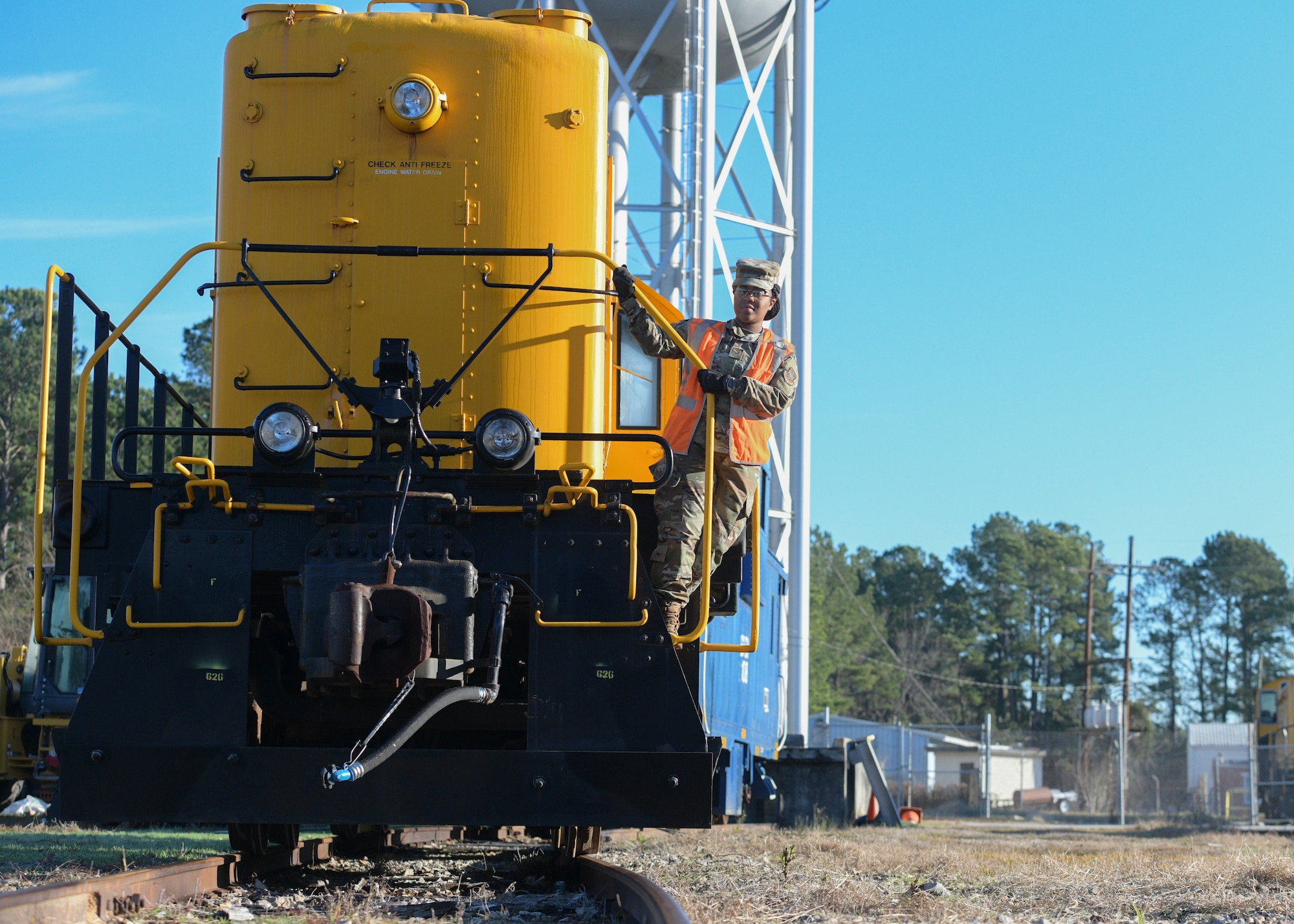 Staff Sgt. Gelisa Inniss, 628th Logistics Readiness Squadron NCO in charge of ground transportation operations center, Naval Weapons Station, stands on a locomotive at Joint Base Charleston NWS in Goose Creek, S.C., Jan. 7, 2020. Innis was the first active duty Airman to complete the Brakeman Switchman Course at Joint Base Langley-Eustis, Virginia. (U.S. Air Force photo by Senior Airman Joshua R. Maund)