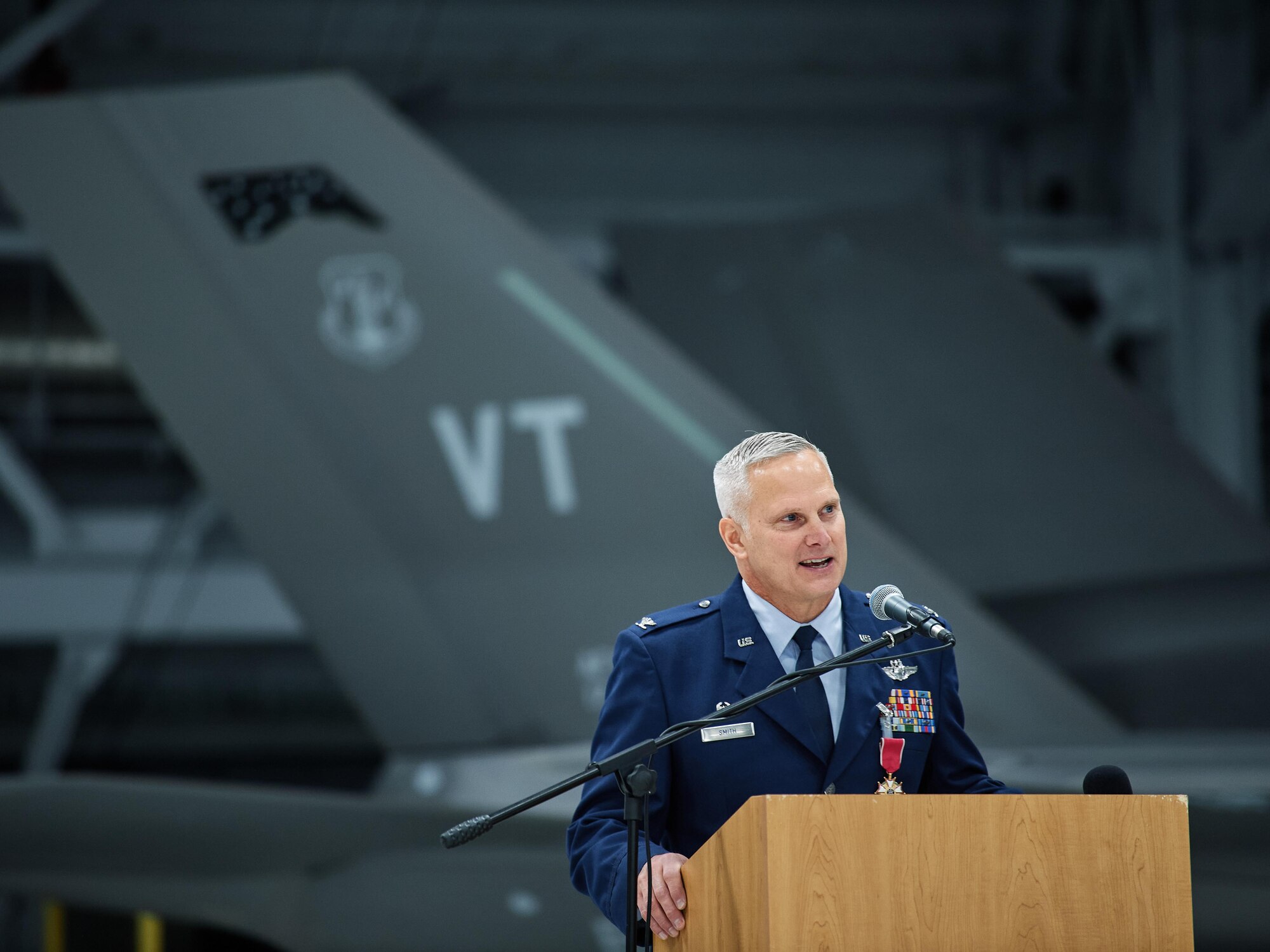 Col. David Smith, outgoing commander of the 158th Fighter Wing, Vermont Air National Guard, addresses wing members, family and friends in attendance during a change of command ceremony