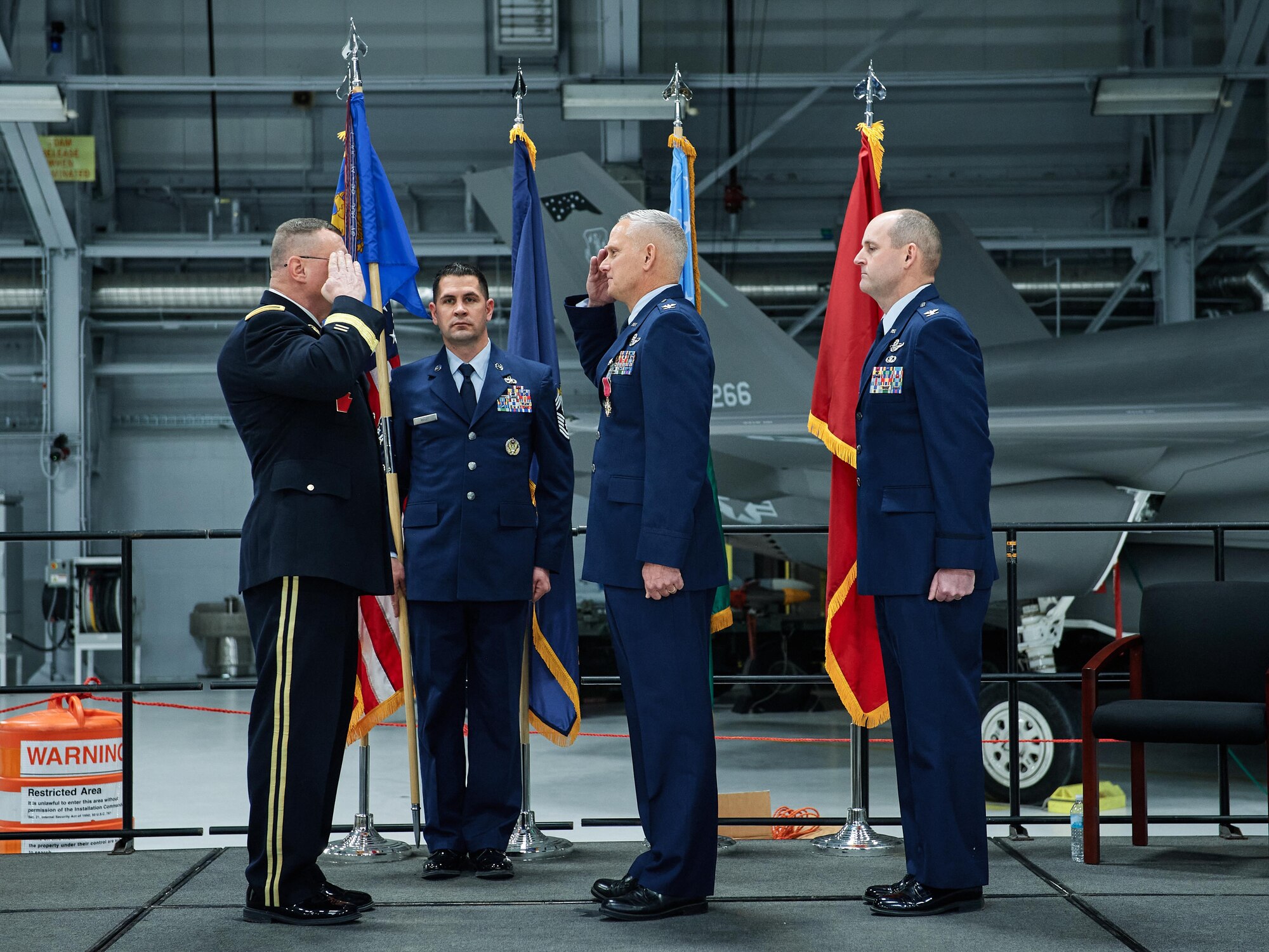 Col. David Smith, outgoing commander of the 158th Fighter Wing, Vermont Air National Guard, relinquishes command of the wing to Army Brig. Gen. Greg Knight