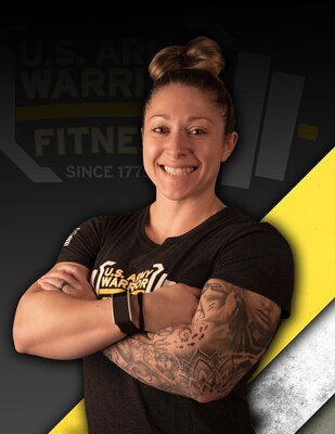 Brown-haired woman with left arm tattooed, crossing her arms in black t-shirt against a black, yellow and white background.