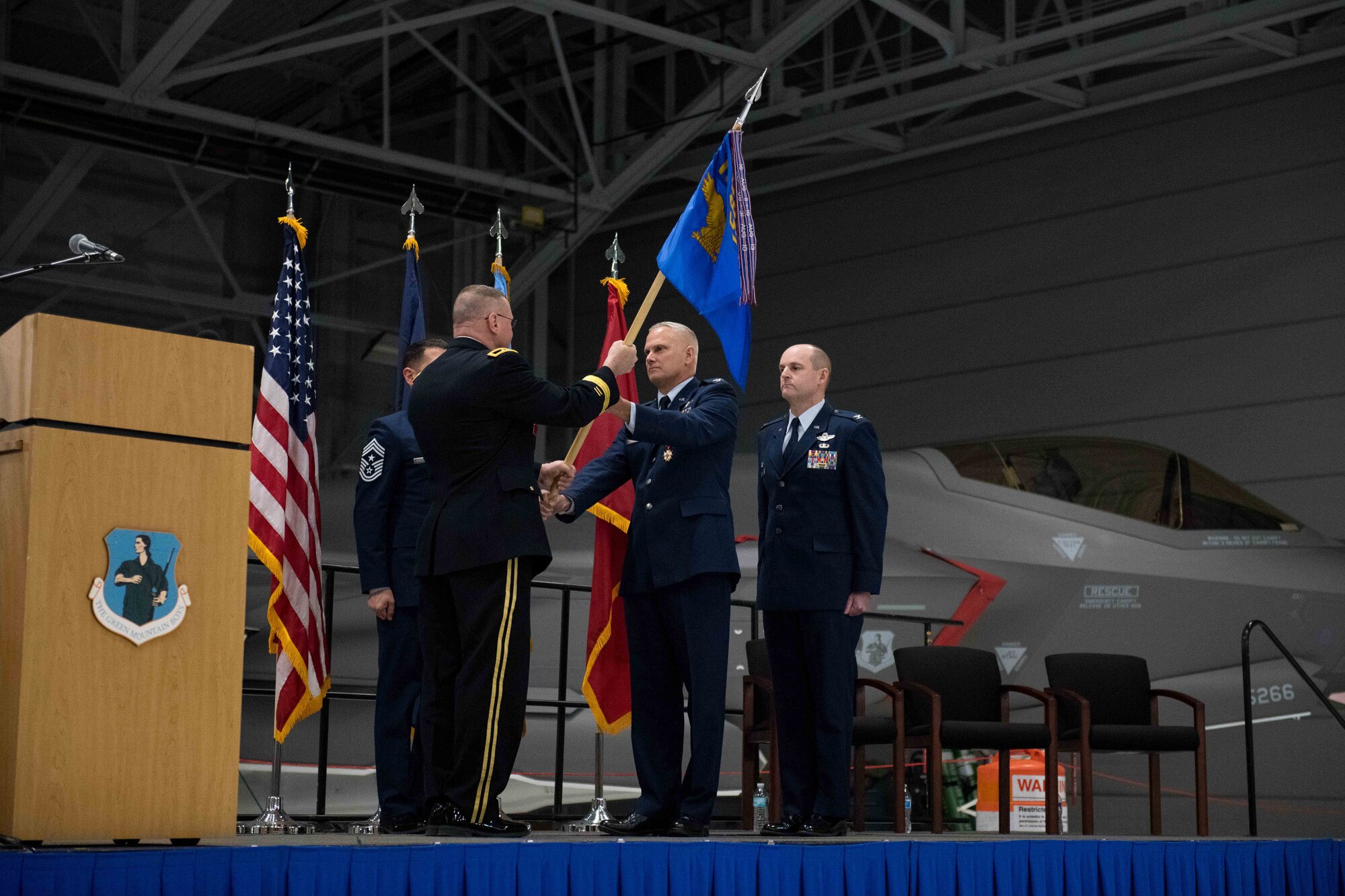 Col. David Smith, outgoing commander of the 158th Fighter Wing, Vermont Air National Guard, relinquishes command of the wing to Army Brig. Gen. Greg Knight