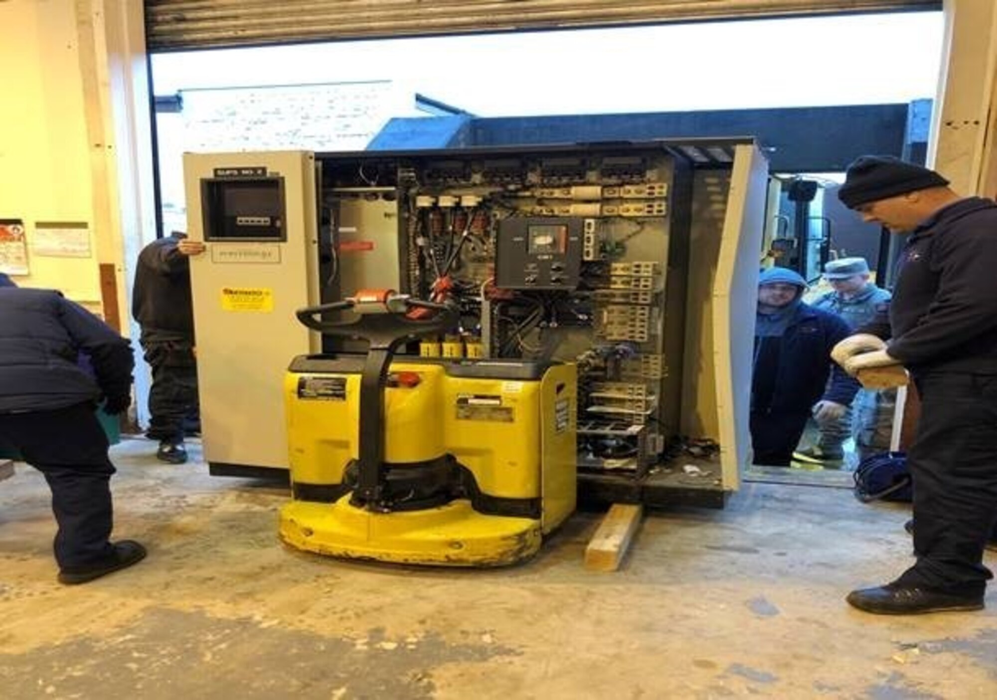 Airmen and civilian personnel from the 422nd Communications and Civil Engineer Squadrons, place a B31 Uninterruptable Power System on a forklift, Nov.14, 2019, at RAF Croughton, England. The B31 UPS helps power the 422nd CS technical control facility that serves as one of the main hubs of communication across 5 MAJCOMS. (Courtesy Photo)