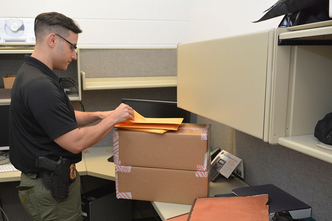 Sgt. Eric Plamp, Defense Intelligence Agency Police Threat Management Unit, inspects mail that has an undisclosed sender.