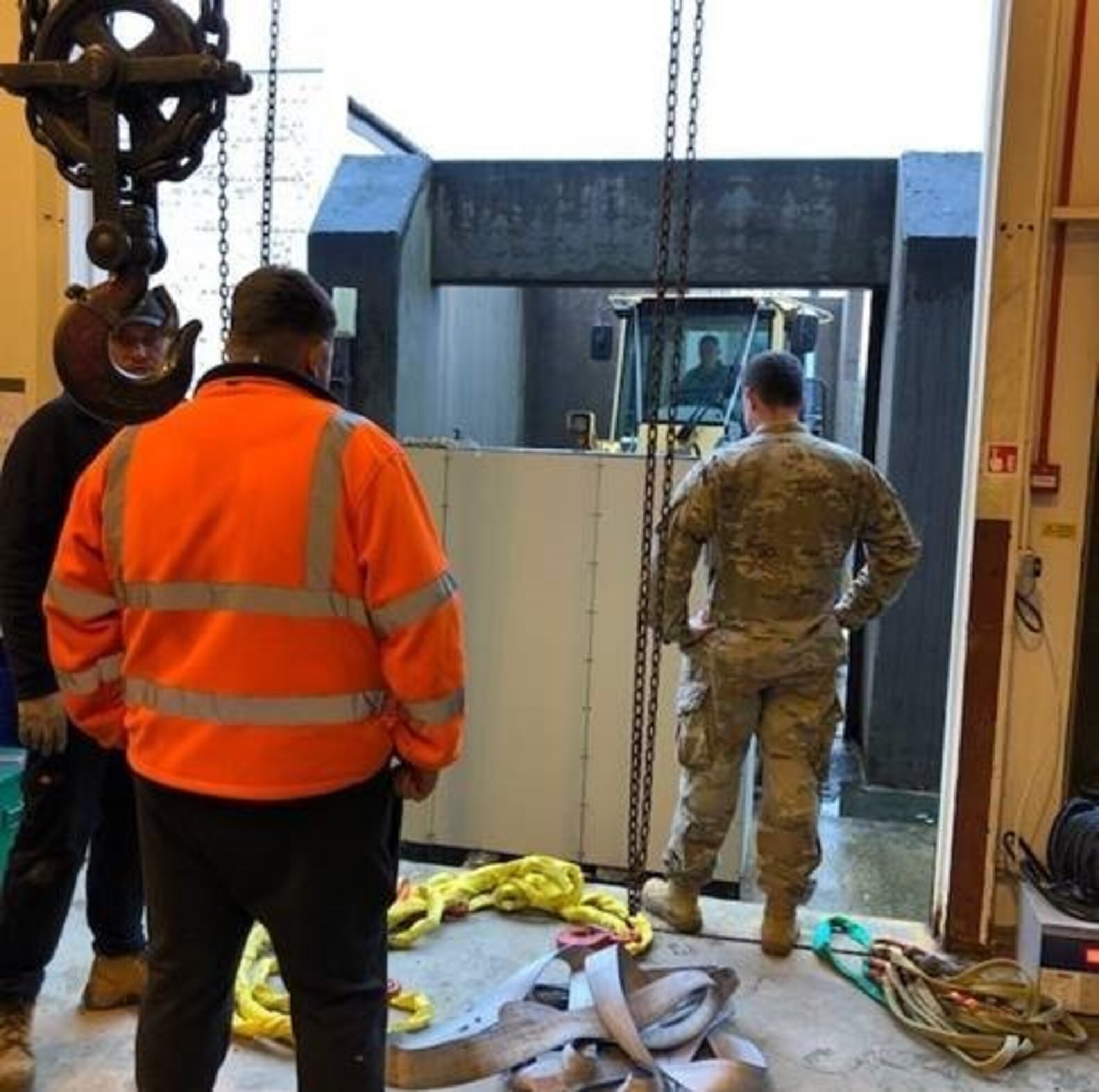 Airmen and civilian personnel from the 422nd Communications and Civil Engineer Squadrons, place a B31 Uninterruptable Power System on a forklift, Nov.14, 2019, at RAF Croughton, England. The B31 UPS helps power the 422nd CS technical control facility that serves as one of the main hubs of communication across 5 MAJCOMS. (Courtesy Photo)
