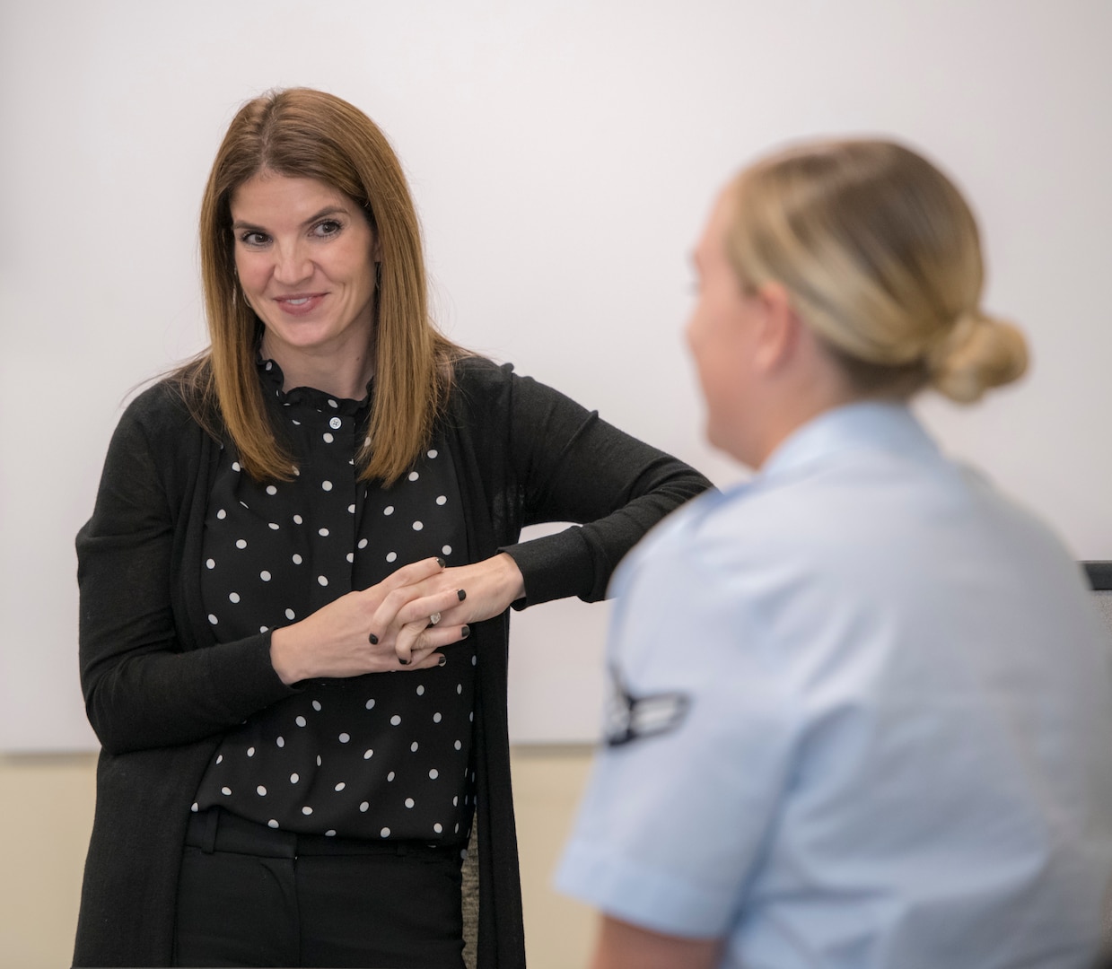 Dr. Julie Landry listens to an Airman during a new student briefing at the 558th Flying Training Squadron at JBSA-Randolph. As the unit psychologist, she teaches students and staff resiliency.