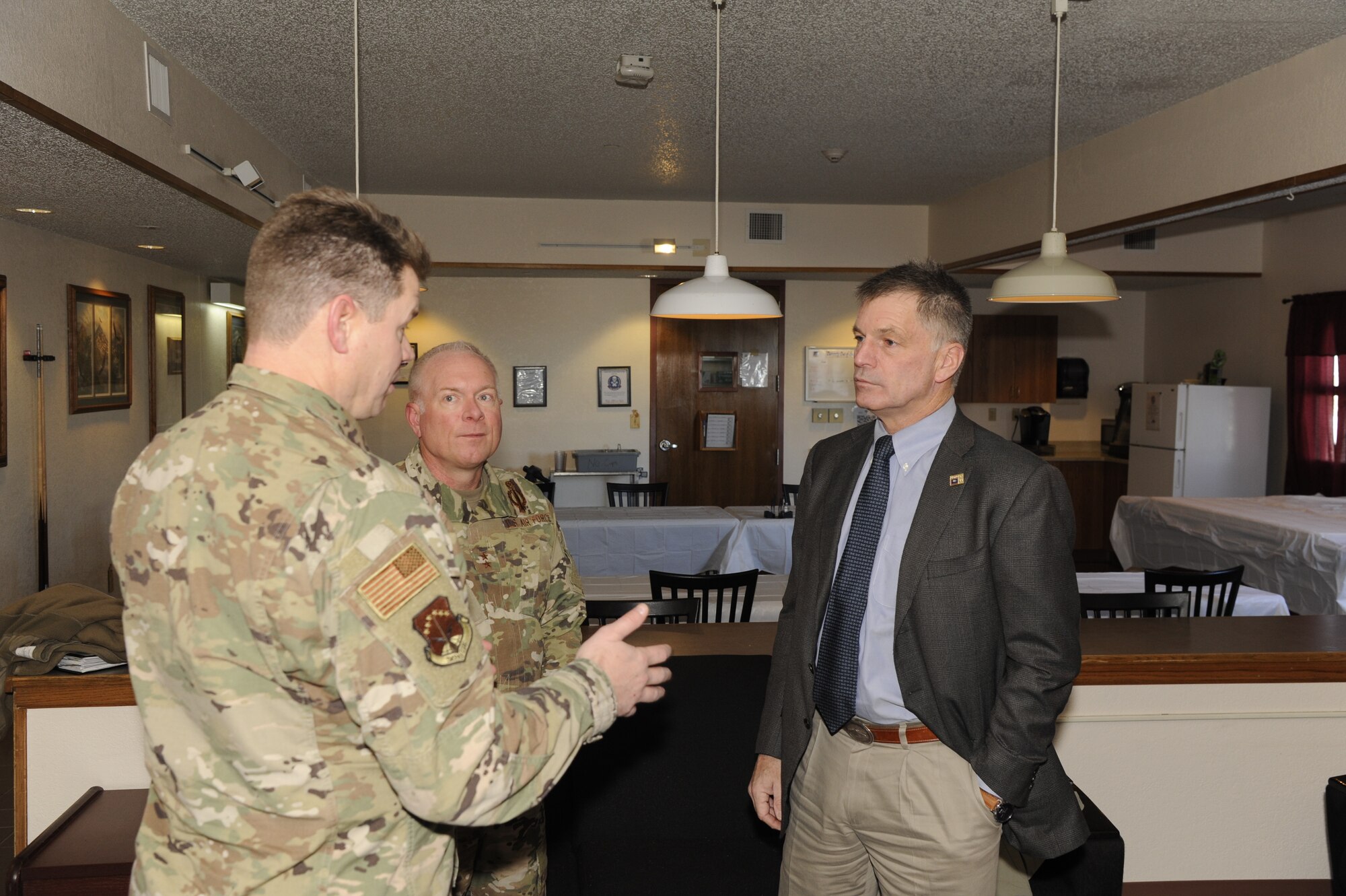 Wyoming Governor Mark Gordon speaks with Maj. Gen. Fred Stoss, 20th Air Force Commander and Col. Peter Bonetti, 90th Missile Wing Commander during an immersion visit Dec. 20. The governor visited a missile alert facility, a launch facility and facilities on base to speak to Airmen and gain a better understanding of the wing's mission.  (U. S. Air Force photo by Glenn S. Robertson)