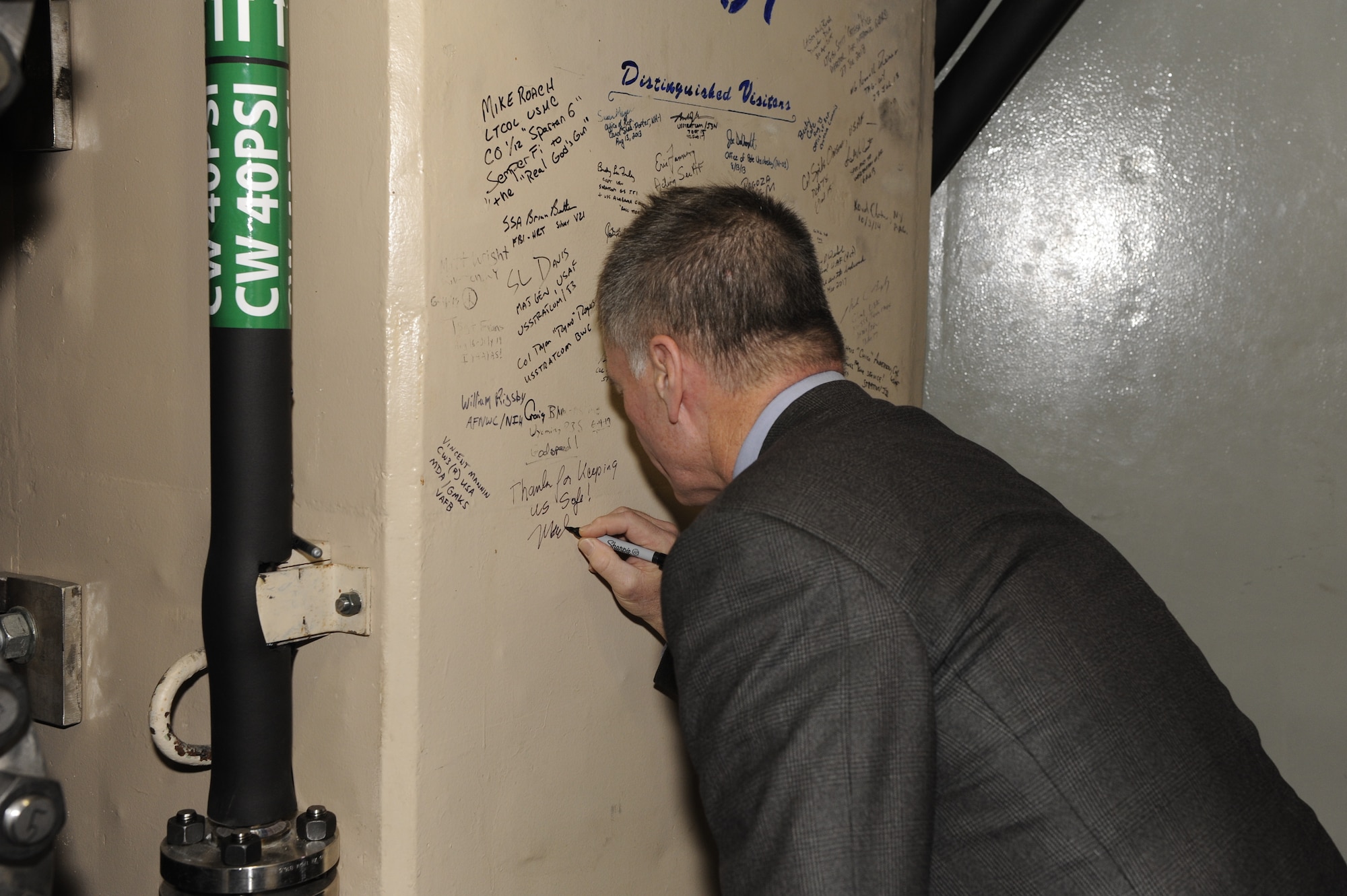 Wyoming governor Mark Gordon signs his name on a wall of a launch control capsule during a visit Dec. 20 to F. E. Warren Air Force Base, Wyo. The governor visited a missile alert facility, a launch facility and facilities on base to speak to Airmen and gain a better understanding of the wing's mission. (U. S. Air Force photo by Glenn S. Robertson)