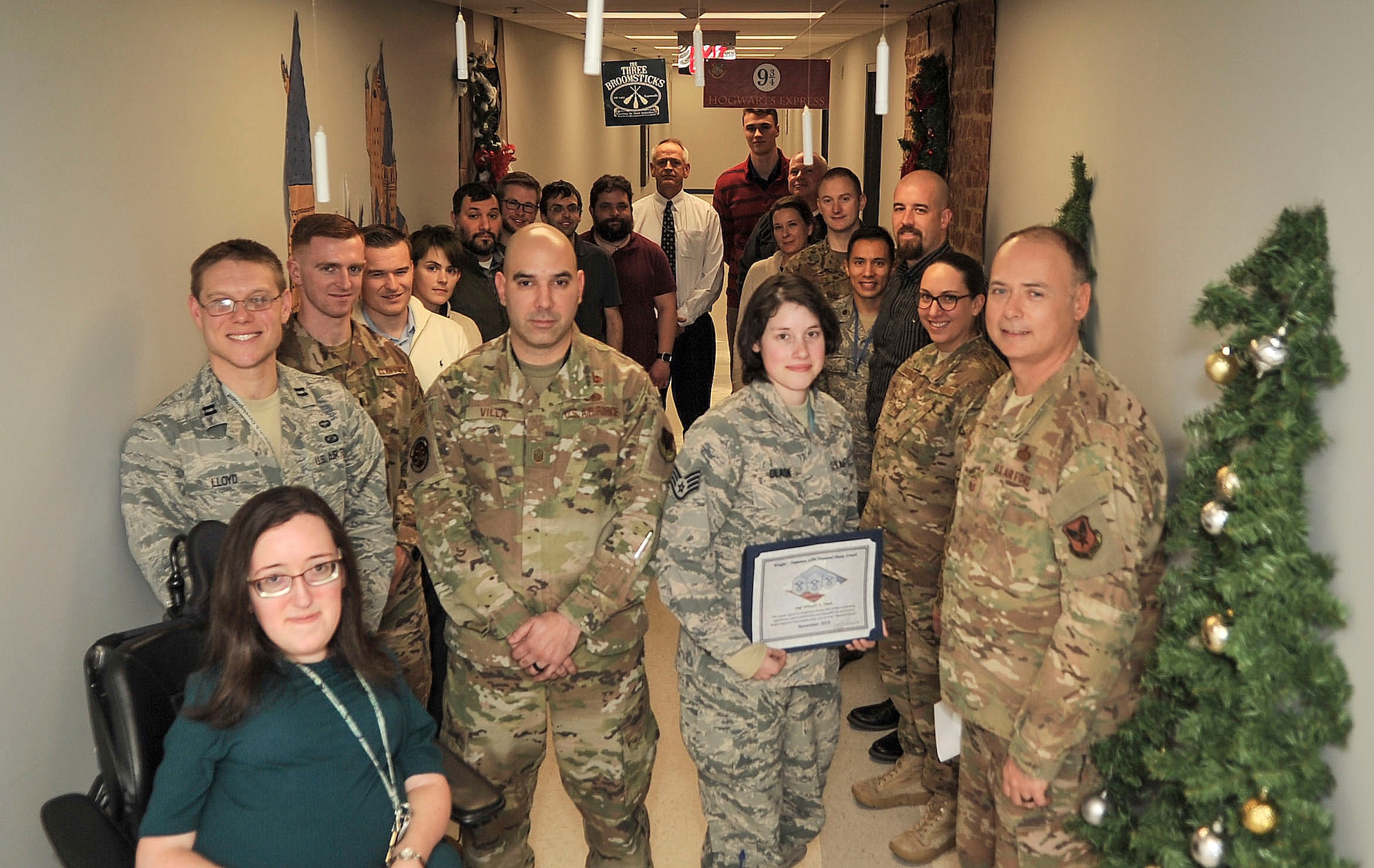 Staff Sgt. Mikayla Dlask, Future Threats Analysis Squadron force modernization analyst, is presented with the Diamond Sharp Award by First Sgts Senior Master Sgt. William Schipper and Juan Villa at the National Air and Space Intelligence Center on Wright-Patterson Air Force Base, Ohio, Dec. 18, 2019. The Diamond Sharp Award recognizes Airmen who have actively demonstrated their commitment to Air Force values or have gone above and beyond in helping others. (U.S. Air Force photos by Staff Sgt. Seth Stang)