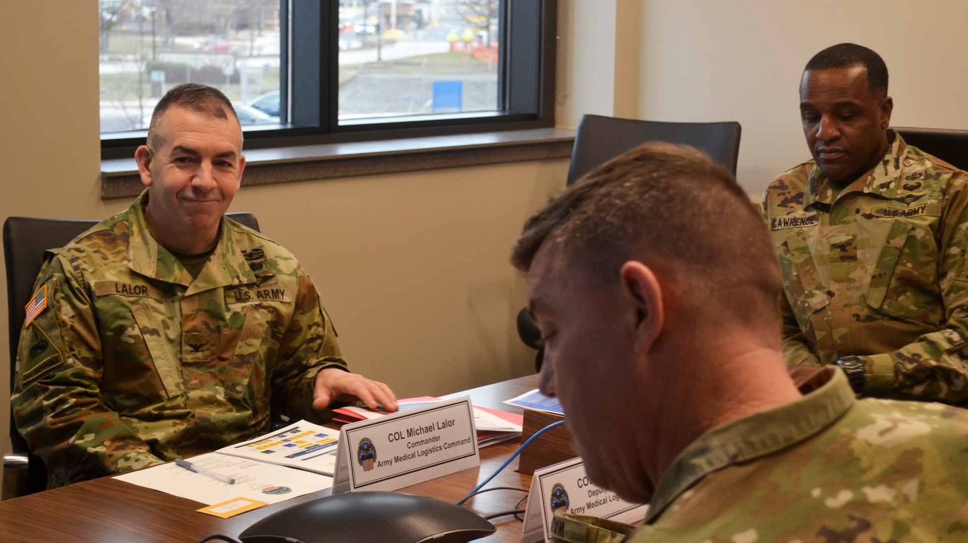 Army Col. Michael Lalor, Army Medical Logistics Command commander, left, sits in on a briefing at DLA Troop Support Jan. 7, 2020 in Philadelphia.