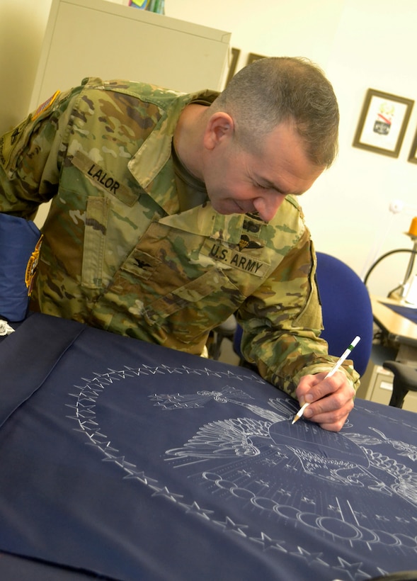 Army Col. Michael Lalor, Army Medical Logistics Command commander, signs the presidential flag during a visit to the Flag Room at DLA Troop Support Jan. 7, 2020 in Philadelphia.