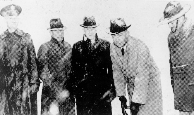 A black and white photo of five men posing for a photo during the ground breaking of Hill Field on Jan. 12, 1940.