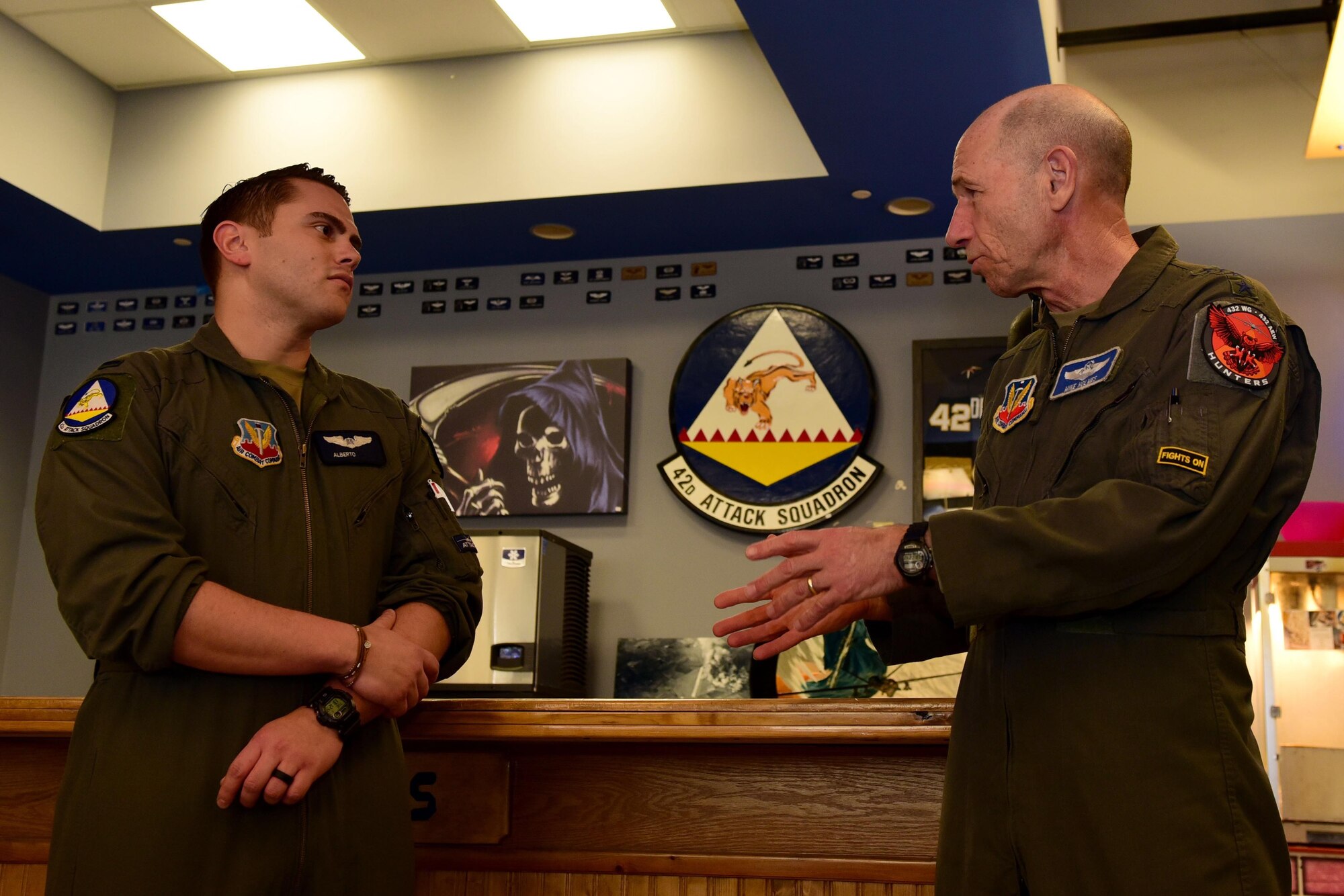 A lieutenant speaks with General Mike Holmes, commander of Air Combat Command, during a visit.
