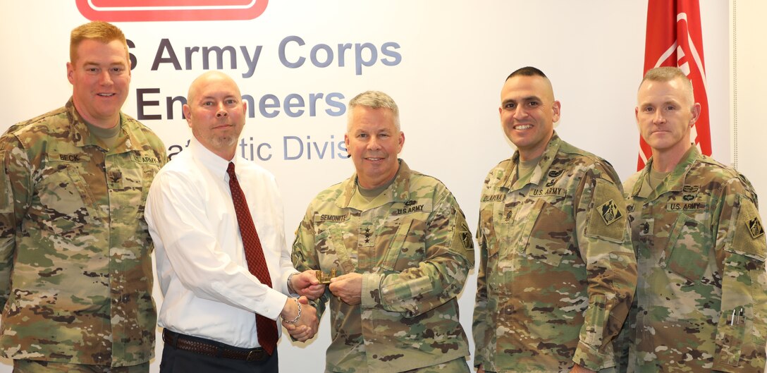 Lt. Gen. Todd T. Semonite, the 54th Chief of Engineers and Commanding General of the U.S. Army Corps of Engineers (center) “coins” Transatlantic Division Logistics Specialist Tim O'Dell for O'Dell's work supporting the men and women at deployed locations throughout the Middle East.