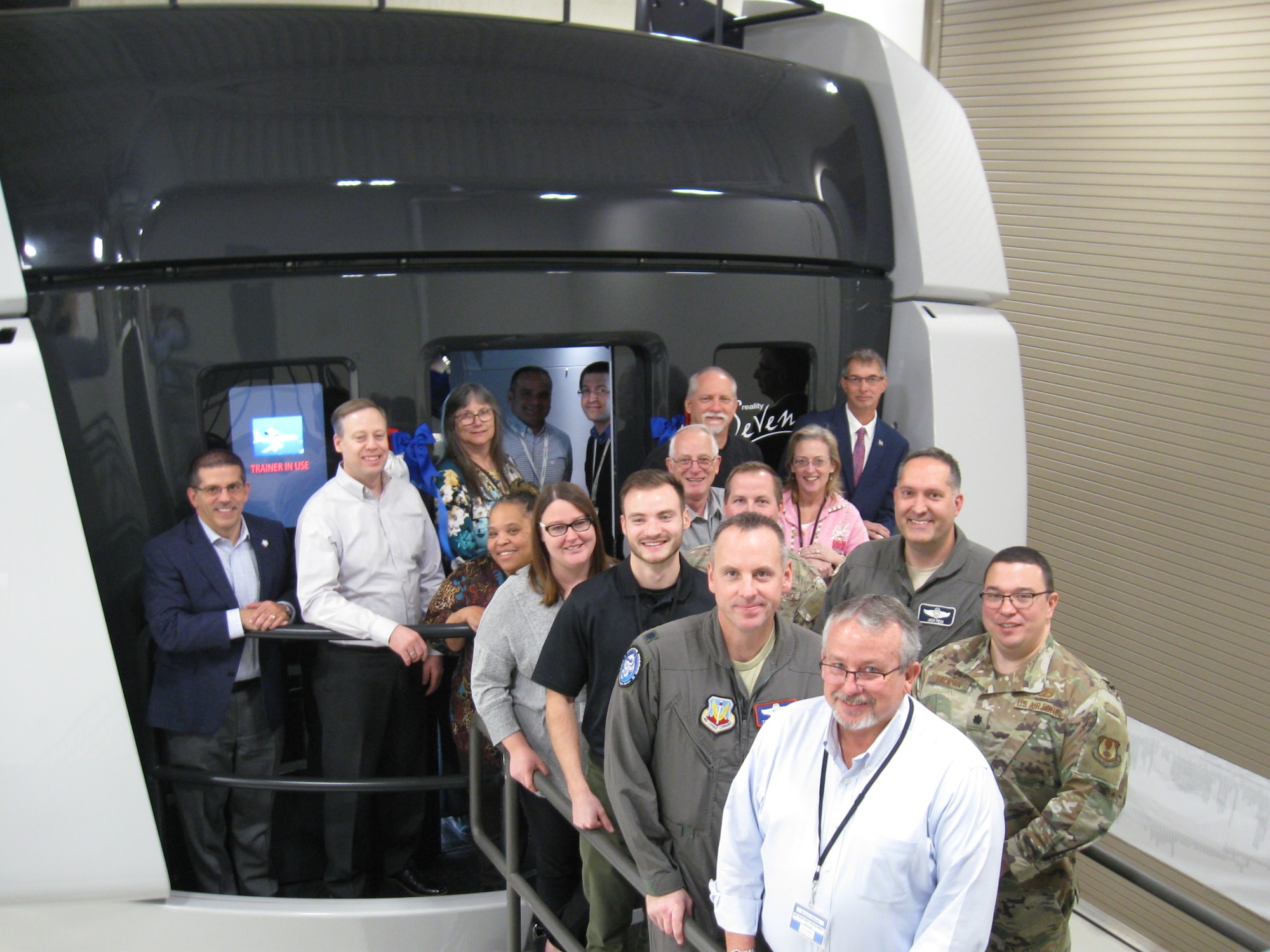 Members of the Simulators Division and 552nd Air Control Group pose in front of the first delivery of the DRAGON Flight Training Device at Tinker Air Force Base, Okla., in December 2019. (Courtesy photo)