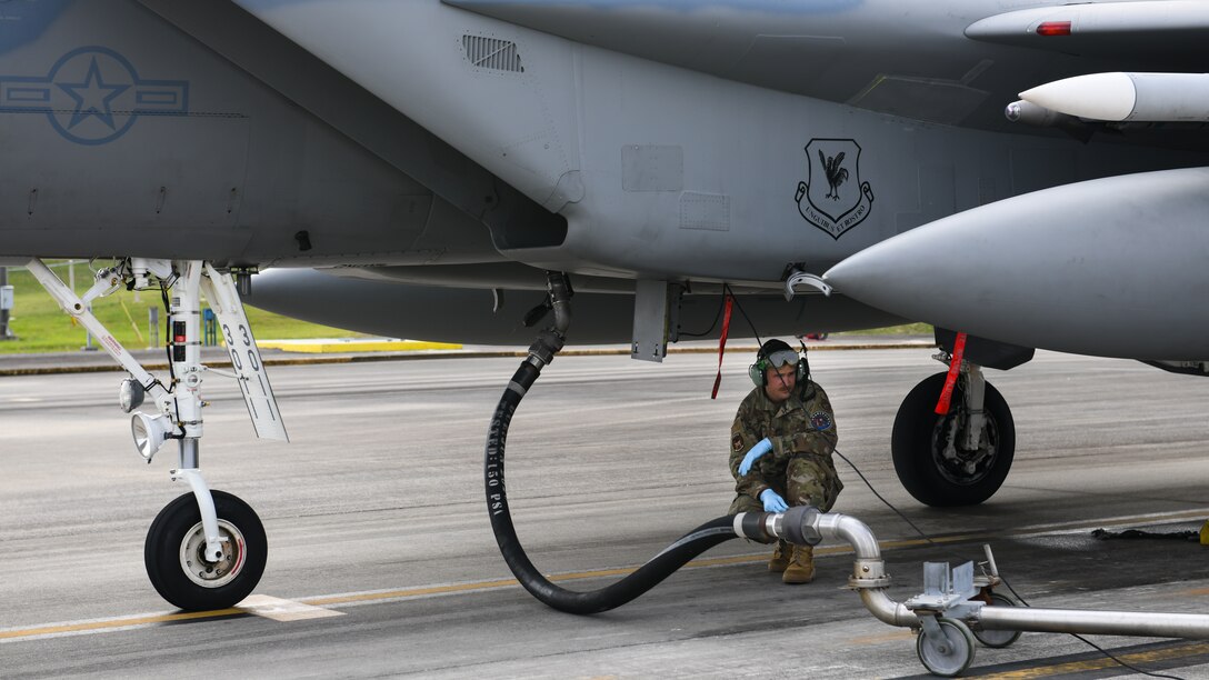 A maintainer from the 18th Aircraft Maintenance Squadron prepares to fuel an F-15C Eagle during Exercise Rumrunner at Marine Corps Air Station Futenma, Japan, Jan. 10, 2020. Airmen from the 18th Wing operate in a safe and e3nvironmentally conscious manner and adhere to strict standards set by Department of Defense and host-governments at all times. (U.S. Air Force photo by Staff Sgt. Benjamin Raughton)