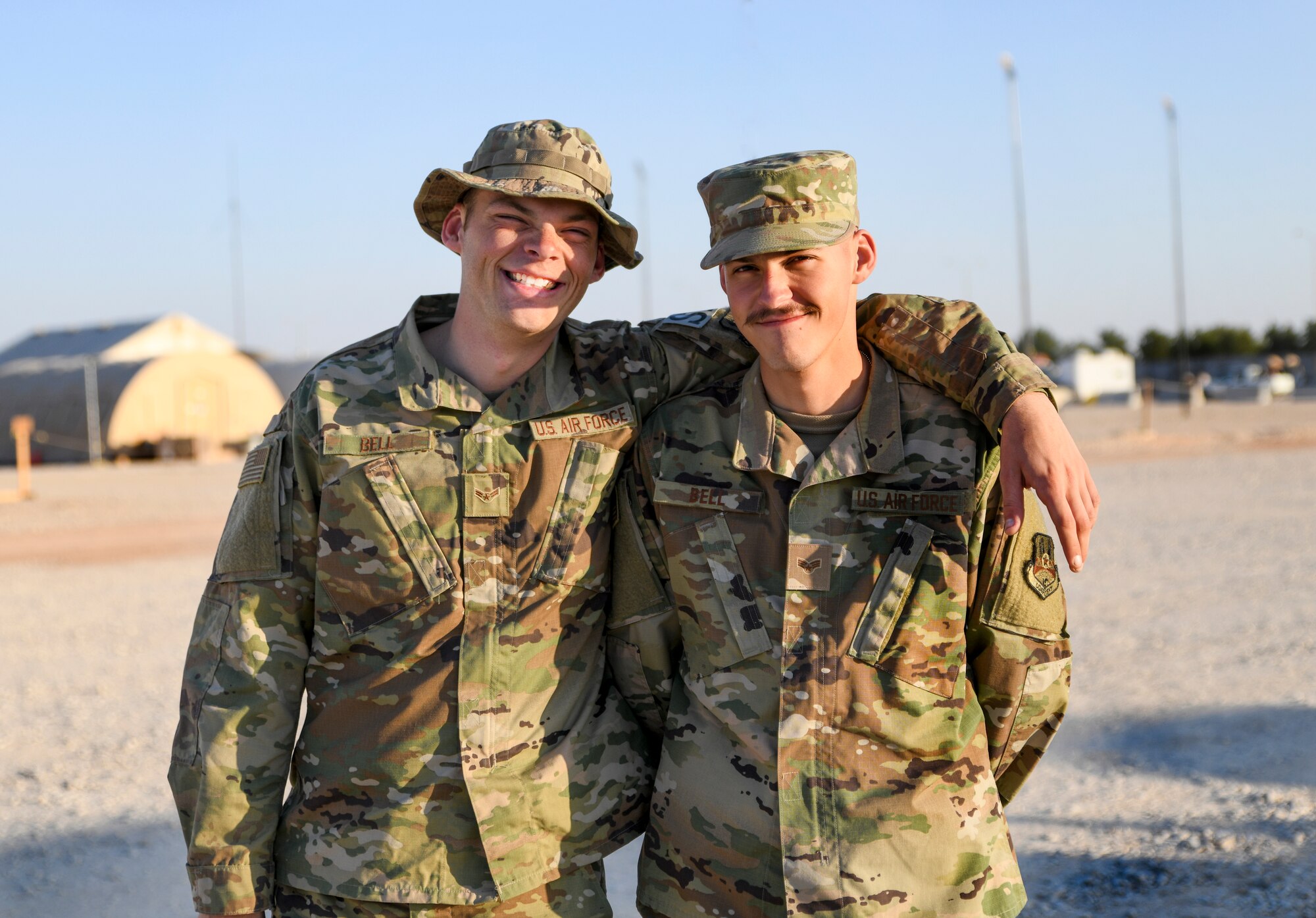 Airman 1st Class Joel Bell, right, 378th Expeditionry Secruity Forces Squadron defender and Senior Airman Jared Bell, left, 378th Expeditionary Logistics Readiness Squadron vehicle maintainer, pose together at Prince Sultan Air Base, Kingdom of Saudi Arabia, Dec. 28, 2019.