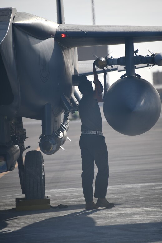 U.S. Air Force Staff Sgt. Zackary Suttles, a crew chief with the 378th Expeditionary Maintenance Squadron, conducts a post landing inspection on an F-15E Strike Eagle at Prince Sultan Air Base, Kingdom of Saudi Arabia, Jan. 4, 2020.