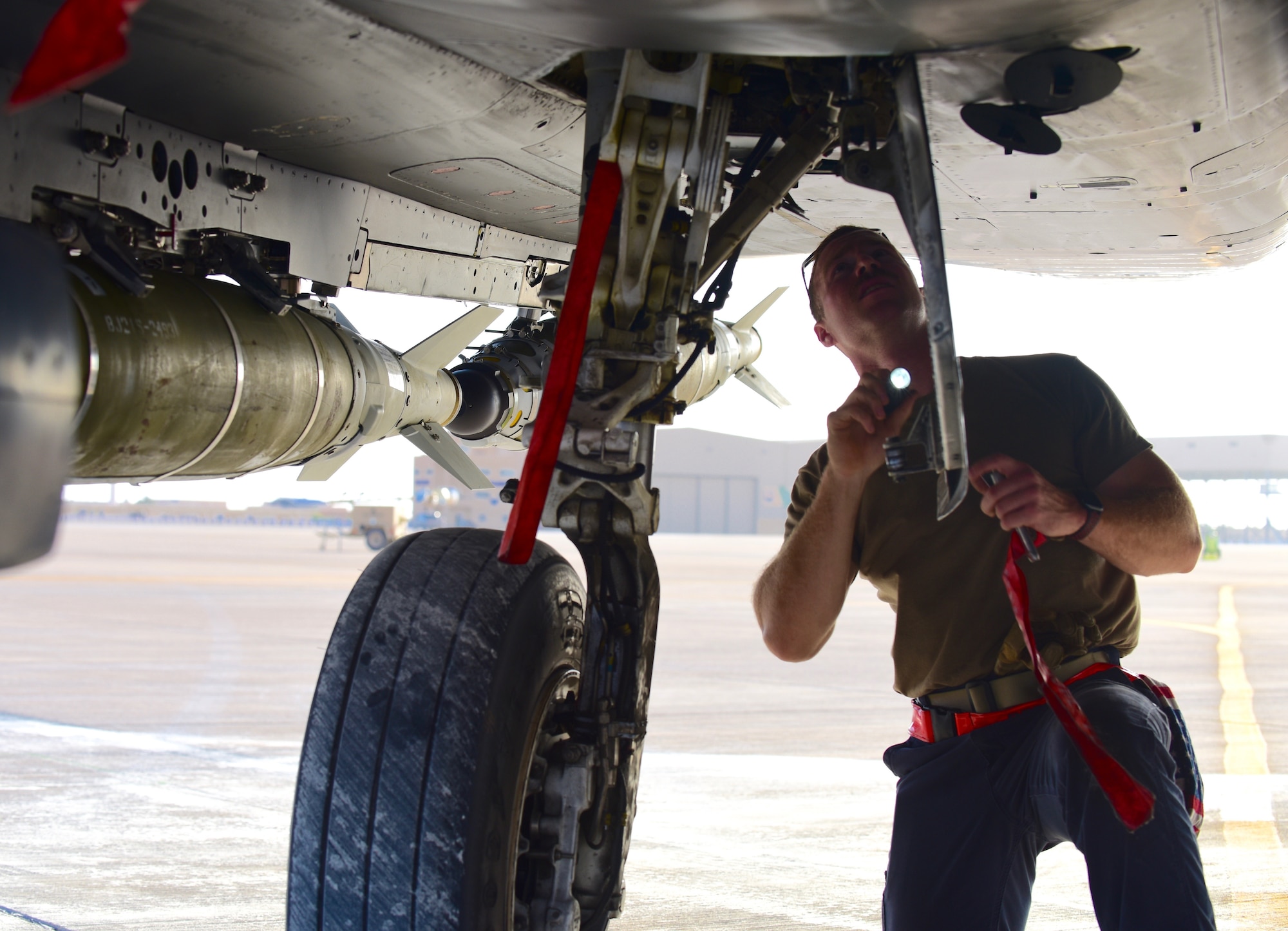 U.S. Air Force Staff Sgt. Zackary Suttles, a crew chief with the 378th Expeditionary Maintenance Squadron, conducts maintenance on an F-15E Strike Eagle at Prince Sultan Air Base, Kingdom of Saudi Arabia, Jan. 4, 2020.