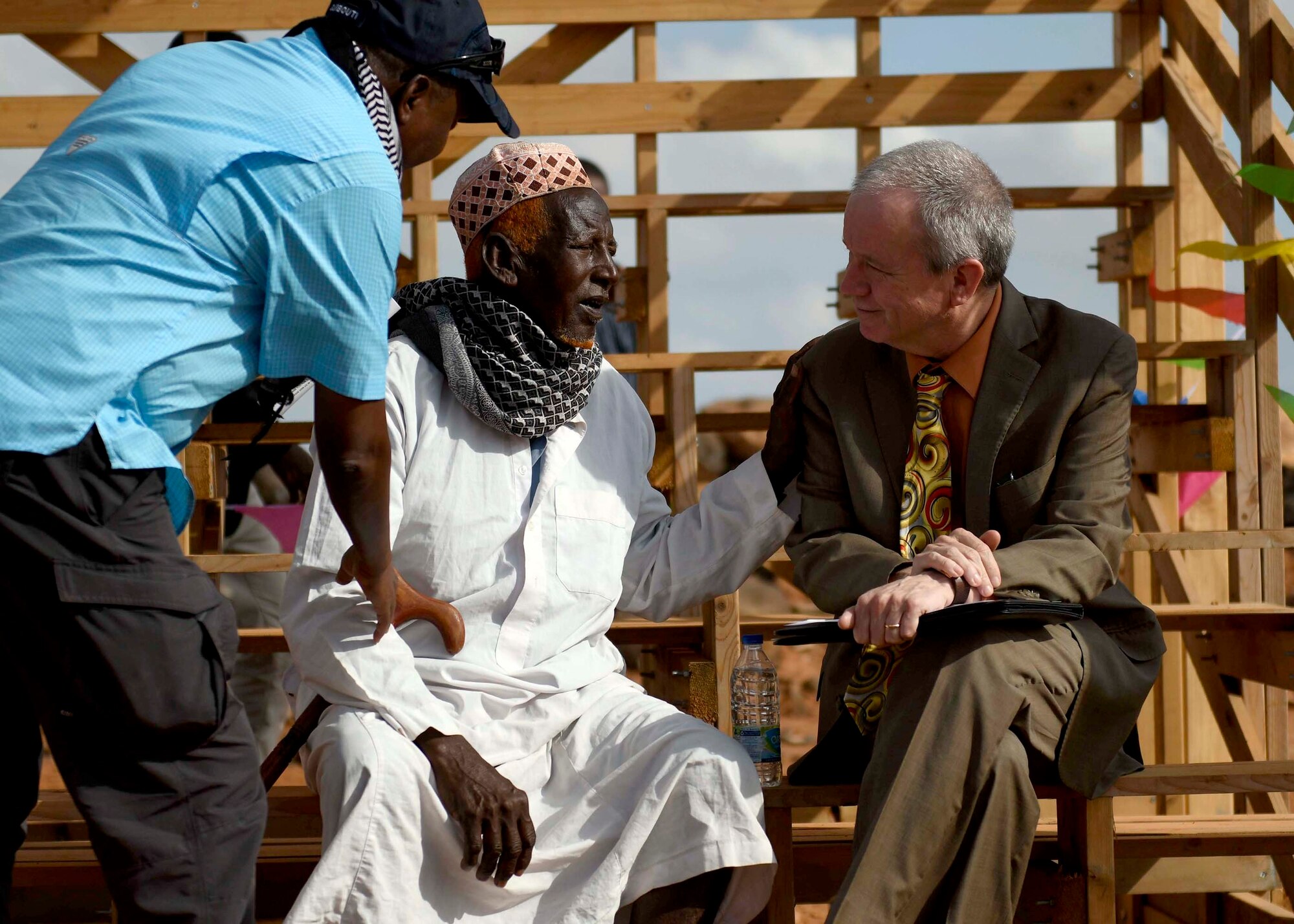 U.S. Ambassador to Djibouti Larry André, right, speaks with a Chabelly village elder at the grand opening of the Chabelly Village soccer field in Chabelly, Djibouti, Dec. 30, 2019. U.S. service member volunteers constructed the soccer field. (U.S. Air Force photo by Staff Sgt. J.D. Strong II)