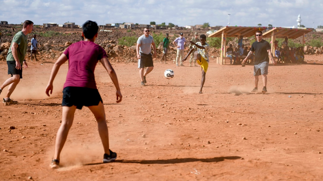 U.S. service members play a game of soccer with Chabelly villagers during the grand opening of the Chabelly Village soccer field in Chabelly, Djibobuti, Dec. 30, 2019. U.S. service member volunteers constructed the soccer field. (U.S. Air Force photo by Staff Sgt. J.D. Strong II)