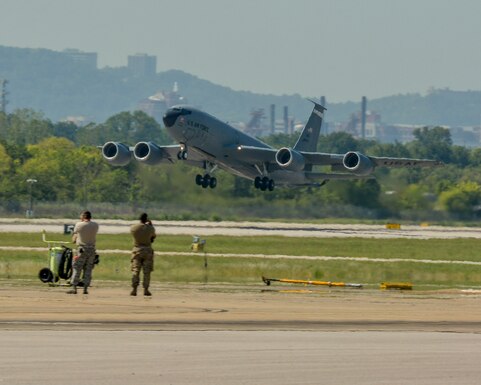 Maintenance personnel from the 117th Air Refueling Wing watch as a KC-135R Stratotanker takes off.