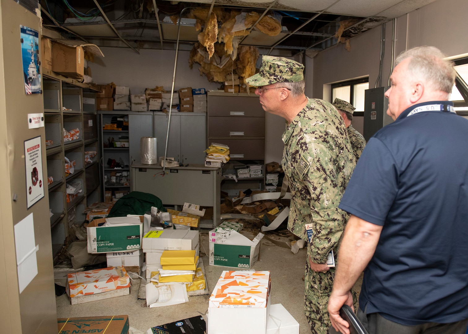 Ed Stewart, NSWC PCD technical director and Capt. Aaron Peters, commander, NSWC PCD, give Rear Adm. Eric Ver Hage, commander, Naval Surface and Undersea Warfare Centers, a tour of hurricane damaged buildings during Ver Hage’s visit to NSWC PCD April 30, 2019.