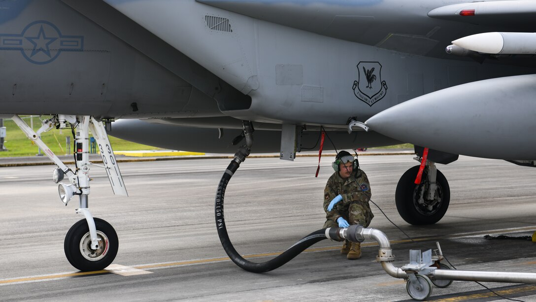 A maintainer from the 18th Aircraft Maintenance Squadron prepares to fuel an F-15 Eagle during Exercise Rumrunner at Marine Corps Air Station Futenma, Japan, Jan. 10, 2020. Airmen from the 18th Wing operate in a safe and e3nvironmentally conscious manner and adhere to strict standards set by Department of Defense and host-governments at all times. (U.S. Air Force photo by Staff Sgt. Benjamin Raughton)