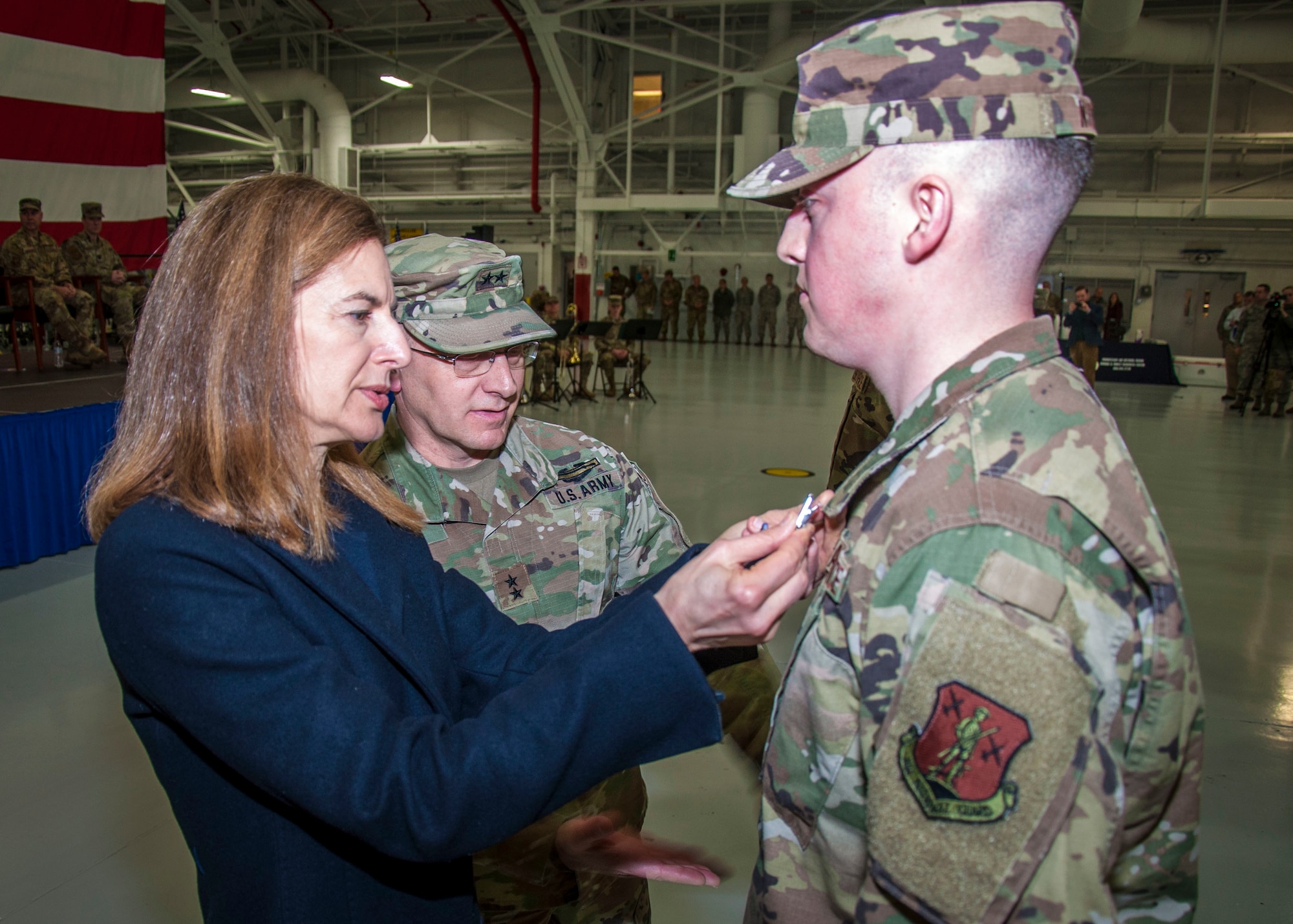Connecticut Lt. Gov. Susan Bysiewicz presents the Air Force Achievement Medal to Senior Airman Thomas Norton, from the 103rd Airlift Wing, during a Freedom Salute Ceremony at Bradley Air National Guard Base, East Granby, Conn. Jan. 4, 2020. This was Norton's first deployment. (Photo by Tim Koster, Connecticut National Guard Joint Force Headquarters Public Affairs)