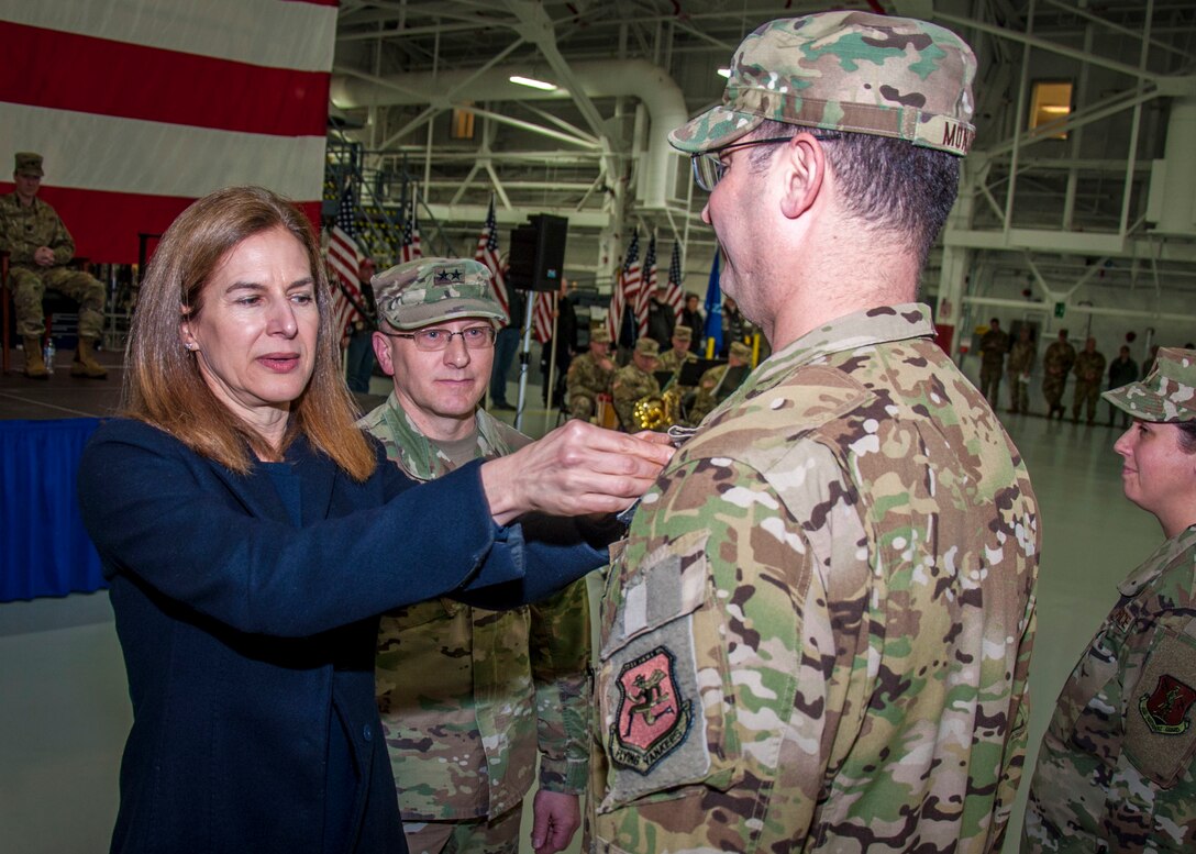 Connecticut Lt. Gov. Susan Bysiewicz presents the Air Force Meritorious Service Medal to Maj. David Monico, during a Freedom Salute Ceremony at Bradley Air National Guard Base, East Granby, Conn. Jan. 4, 2020. Monico served as the director of operations for the 779th Expeditionary Airlift Squadron and led the daily operations of two Air National Guard squadrons which were melded into one max-efficient Air and Space Expeditionary Force. (Photo by Tim Koster, Connecticut National Guard Joint Force Headquarters Public Affairs)