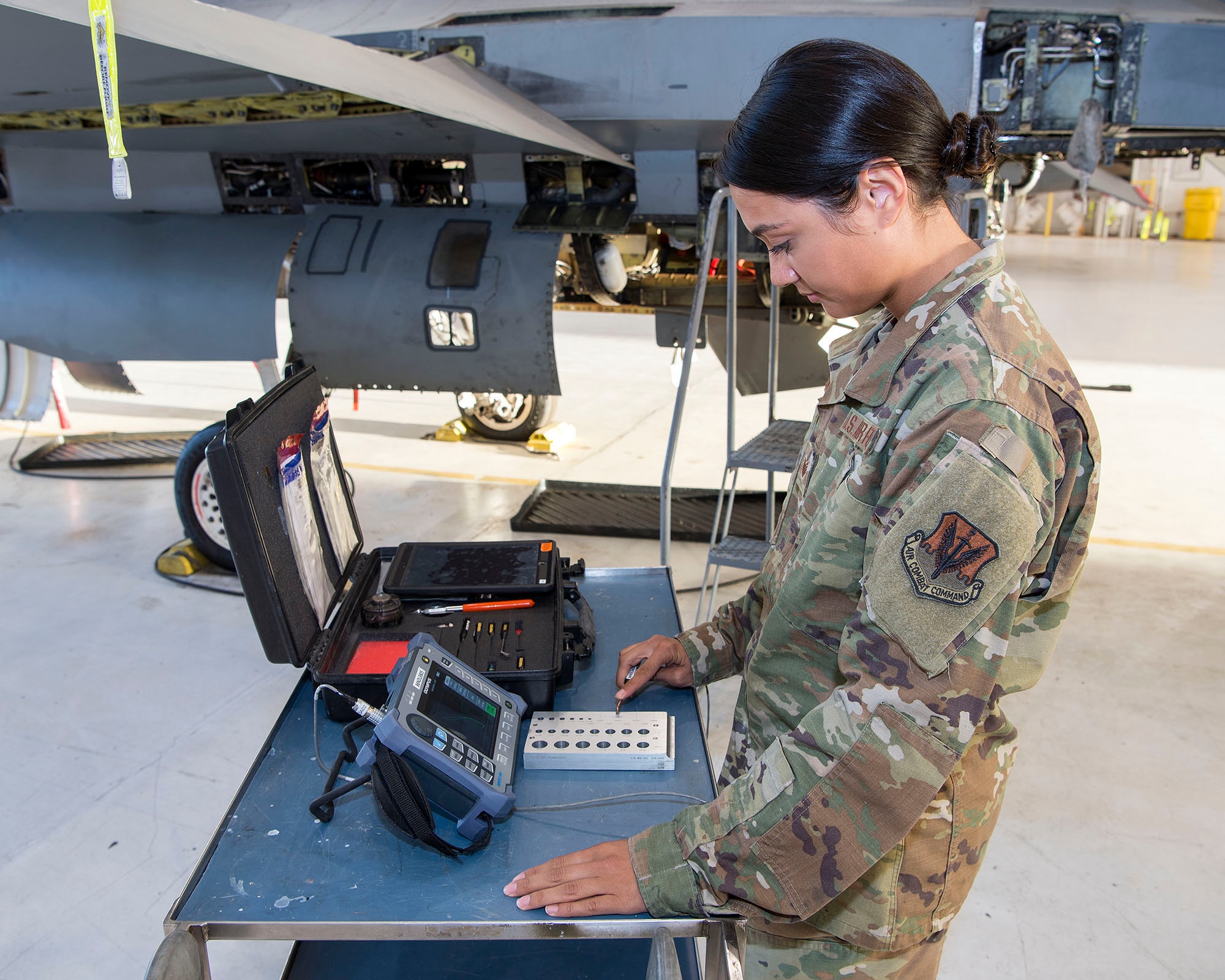 Female Airman conducting test on F-16