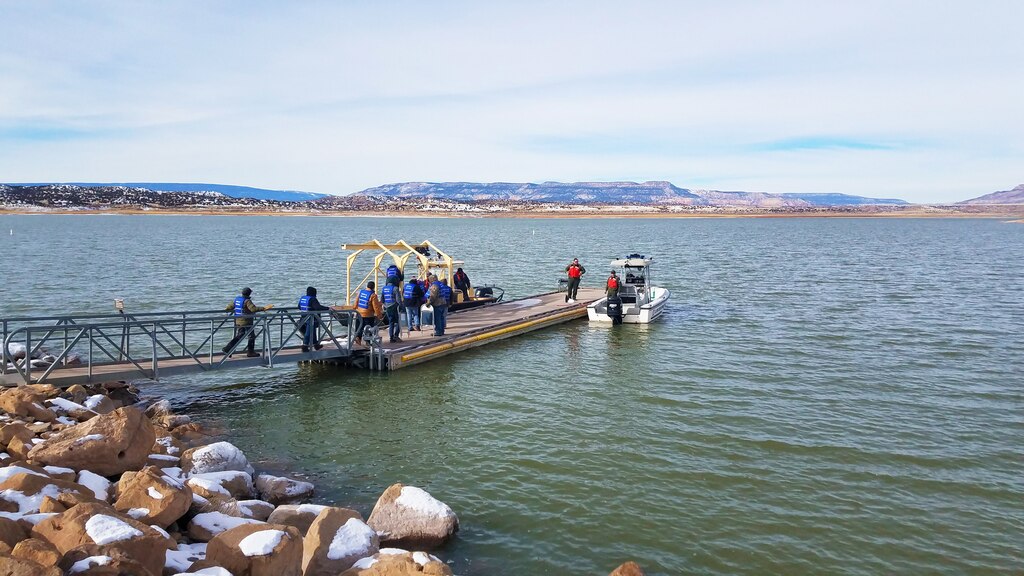 Volunteers (in blue) prepare to board a boat to help count eagles from the lake during the annual eagle watch at Abiquiu Lake, Jan. 4, 2020. This year, 66 volunteers participated in counting eagles from three stationary positions on shore and two boats on the lake.